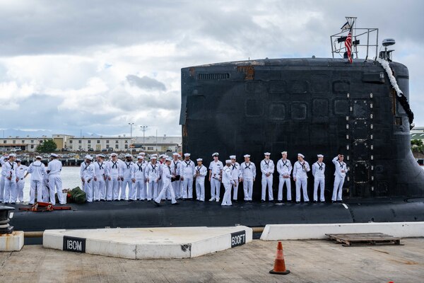Sailors assigned to the Virginia-class fast-attack submarine USS Missouri (SSN 780) wait to disembark as the boat returns to Joint Base Pearl Harbor-Hickam from deployment in the 7th Fleet area of responsibility.