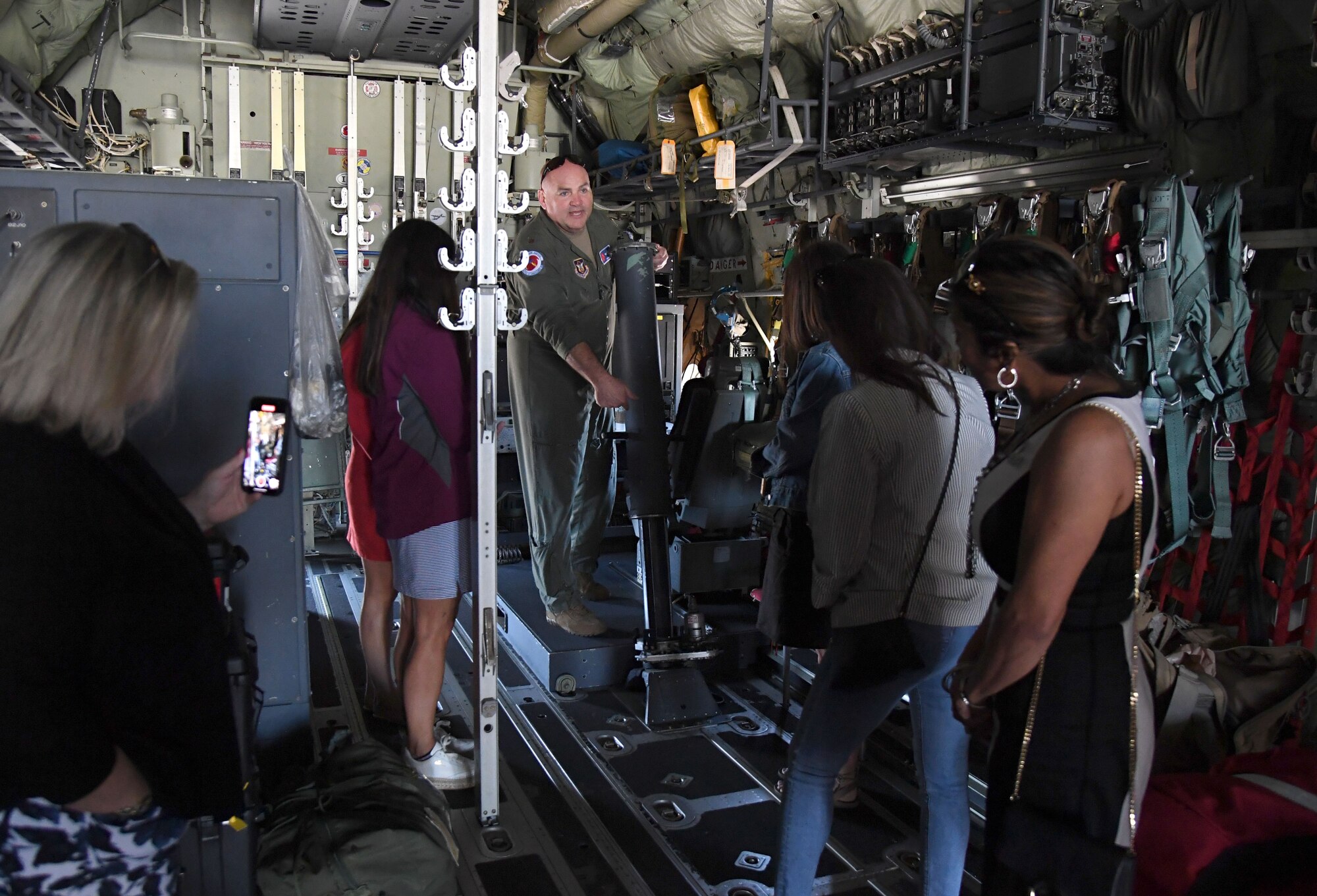 U.S. Air Force Maj. Kendall Dunn, 53rd Weather Reconnaissance Squadron instructor pilot, provides a tour of a C-130 aircraft for Rapiscan Systems Classic guests at Keesler Air Force Base, Mississippi, March 31, 2022. The tour also included a military working dog demonstration and a tour of the Fisher House. (U.S. Air Force photo by Kemberly Groue)