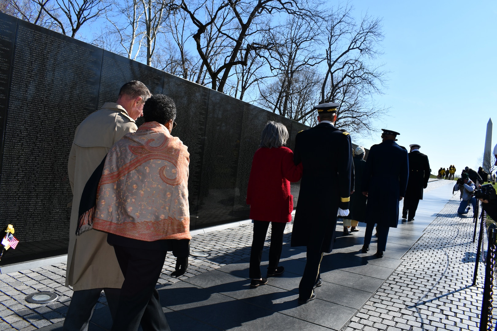 Ms. Fern Sumpter Winbush, Defense POW/MIA Accounting Agency Principal Deputy Director, and Vietnam Veteran and Gold Star brother Col. Al Shine leave a ceremony at the Vietnam War Memorial on National Vietnam Veterans Day, March 29, 2022 in Washington, DC. Since 1973, the remains of more than 1,000 Americans killed during the Vietnam War have been identified and returned to their families for burial with full military honors. The Agency vigorously pursues the fullest possible accounting for 1,584 missing American personnel from the war to include civilians. (Defense Department photo by Ashley M. Wright)