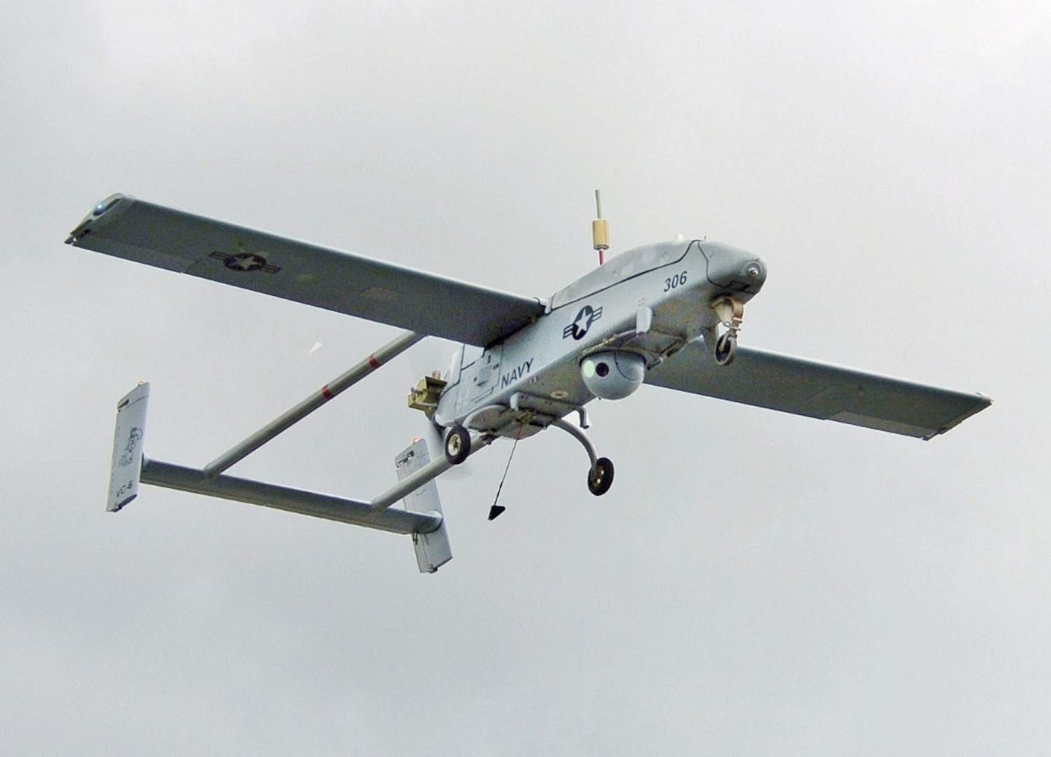 An U.S. Navy RQ-2B Pioneer Unmanned Aerial Vehicle, assigned to the VC-6) uses its sensor turret to scan at the Webster Field Annex of Naval Air Station Patuxent River, Maryland. 2005 (Photo by: Mate 2nd Class Daniel J. McLain, USN)