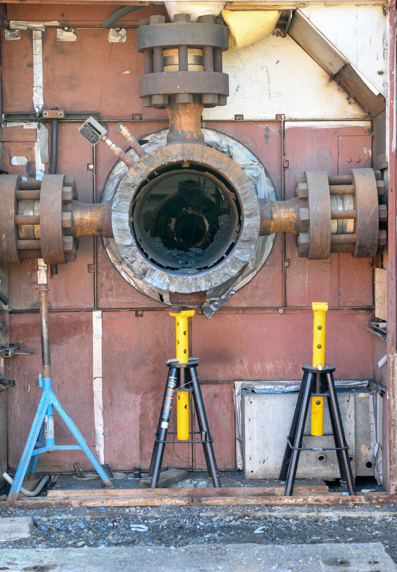 Outside the north wall of the Tunnel E test bay, the upstream end of a large electric resistance heater formerly housed its electrical connects to the Heater Control Building.