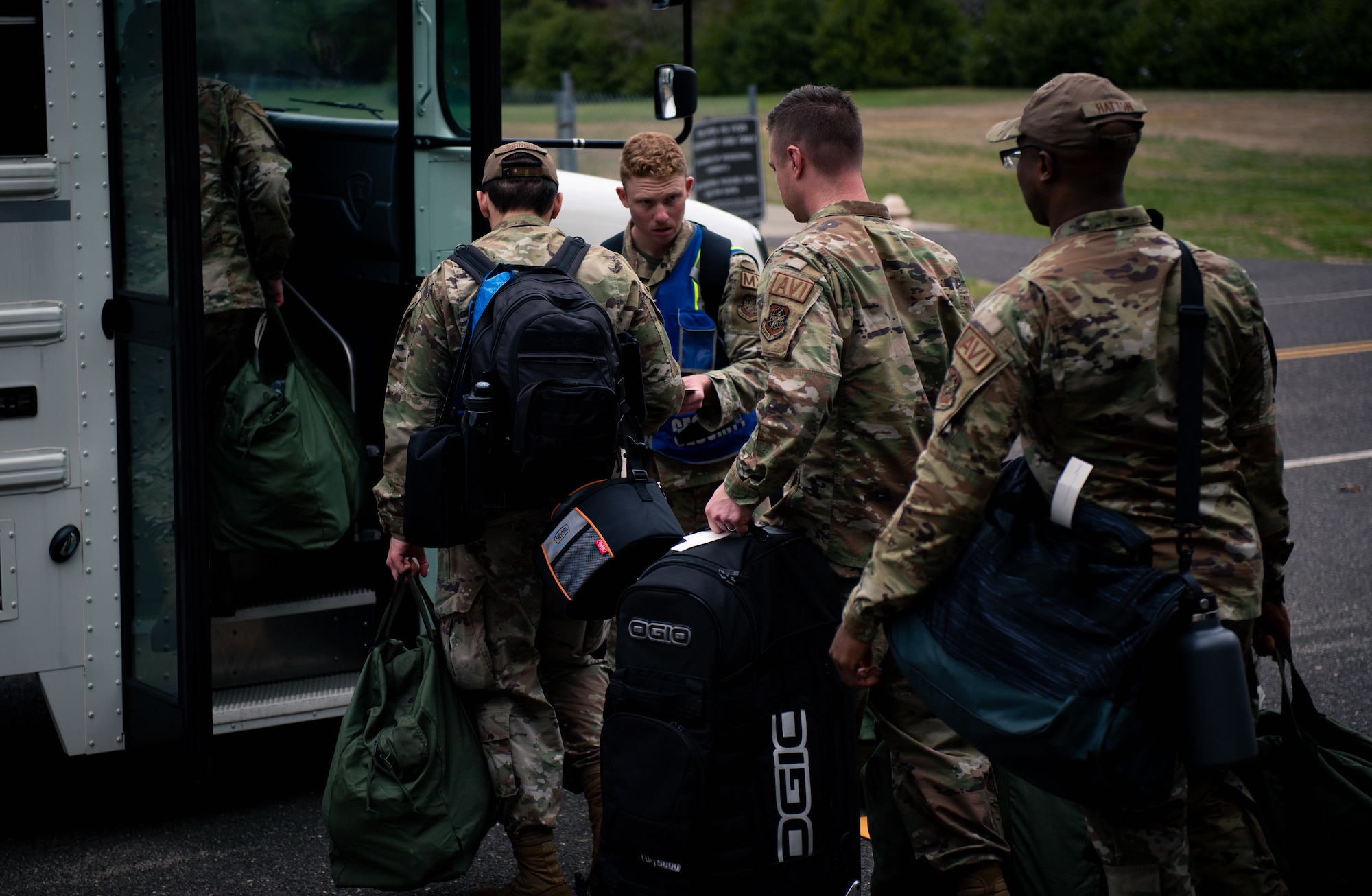 Airmen from the 305th Air Mobility Wing load into a bus after being processed from the Personnel Deployment Function during Readiness Exercise 2022 on Joint Base McGuire-Dix-Lakehurst, March 31, 2022. Readiness exercises demonstrate Air Mobility wings are ready to provide operationally ready, deliberately developed and professionally led Airmen to deploy and support operations in contested environments