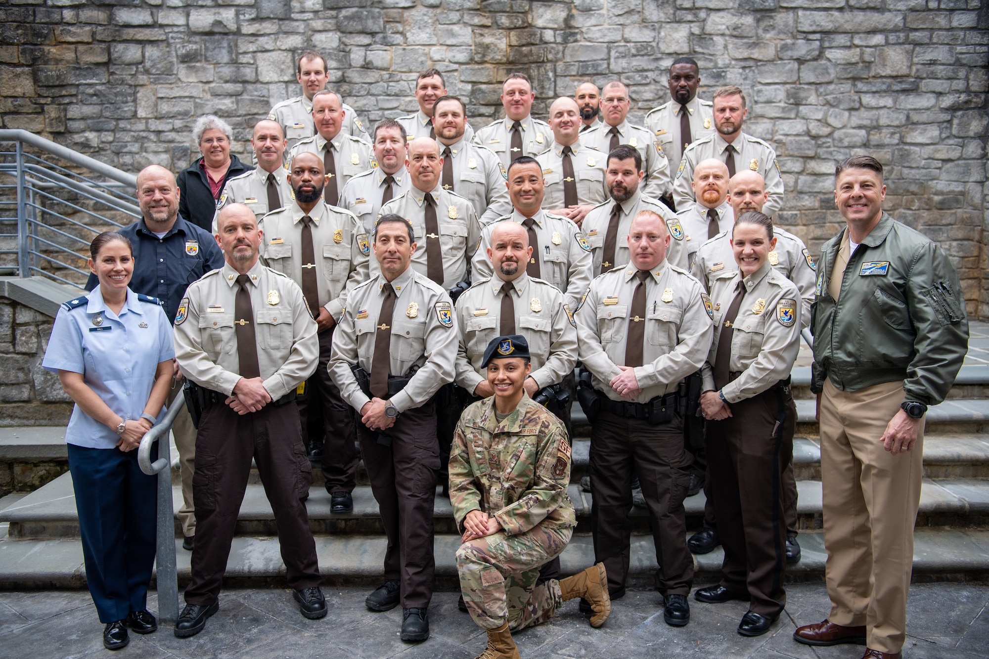 A group of U.S. Fish and Wildlife Law Enforcement officers and service members pose for a photo.