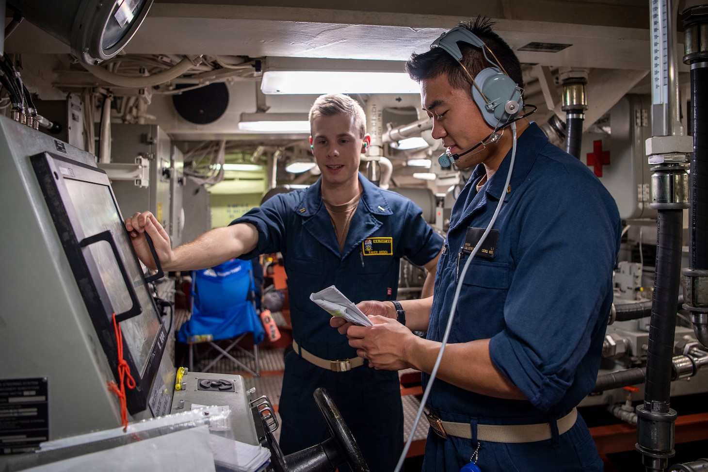 Ensign Xavier Brenza, left, from Boulder, Colorado, and Ensign Brian Li, from Carmel, Indiana, man aft steering aboard the Arleigh Burke-class guided-missile destroyer USS Dewey (DDG 105) while participating in Surface Warfare Advanced Tactical Training (SWATT). SWATT provides the Fleet opportunities to complete the tactical exercise required for increased lethality and tactical proficiency.