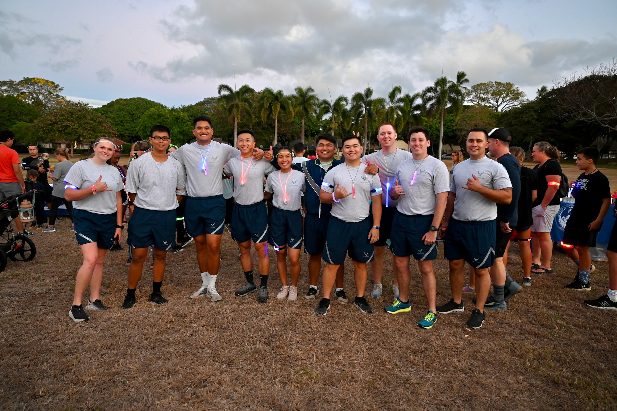 Members from the University of Hawaii at Manoa Air Force Reserve Officer Training Corps program attend the Sexual Assault Awareness and Prevention Month glow run at Joint Base Pearl Harbor-Hickam, Hawaii, April 1, 2022. Cadets and cadre members participated in the 5k run around the Hickam-side of JBPHH to help raise awareness for sexual assault and resources for victims in the military. (U.S. Air Force photo by 1st Lt. Benjamin Aronson)