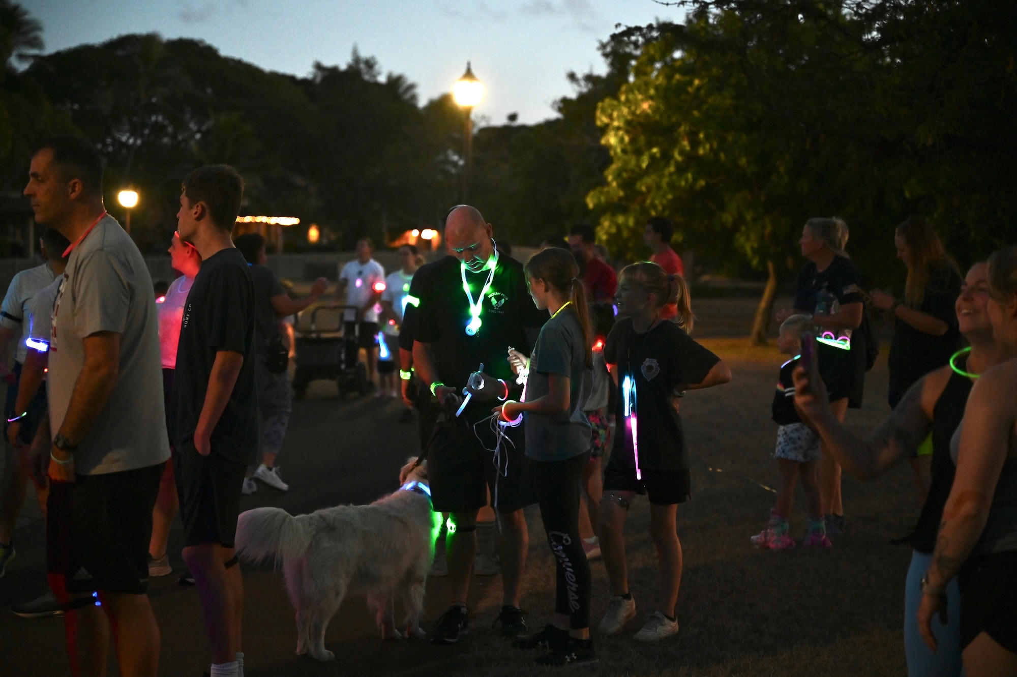 Col. Robert Brown, 15th Wing vice commander, prepares for the Sexual Assault Awareness and Prevention Month glow run with his family at Joint Base Pearl Harbor-Hickam, Hawaii, April 1, 2022. The Department of Defense observes SAAPM by focusing on creating the appropriate culture to eliminate sexual assault and requiring a personal commitment from all Service members. (U.S. Air Force photo by 1st Lt. Benjamin Aronson)