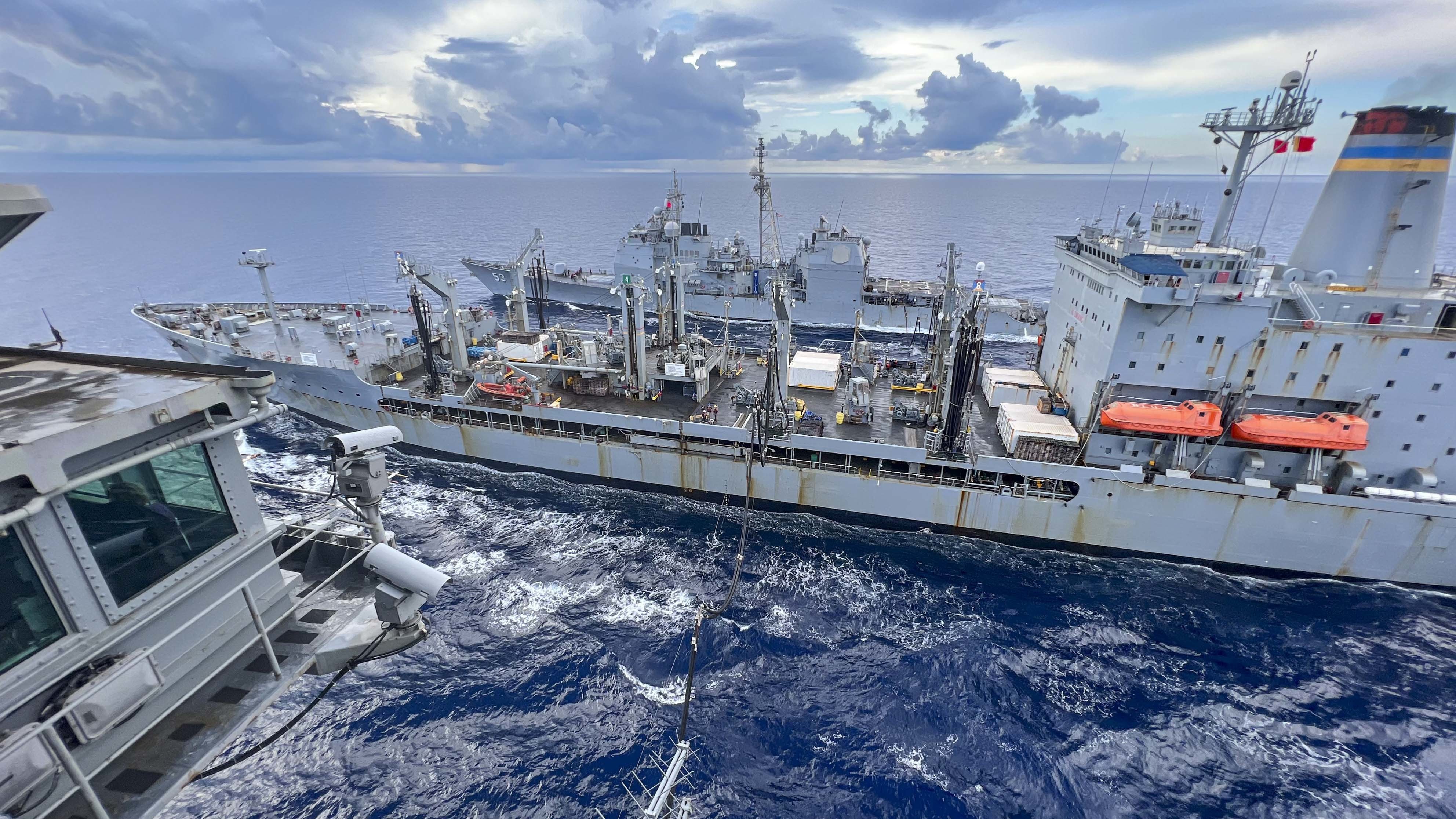 USS Abraham Lincoln (CVN 72) conducts a fueling-at-sea with USNS Guadalupe (T-AO 200) and USS Mobile Bay (CG 53).