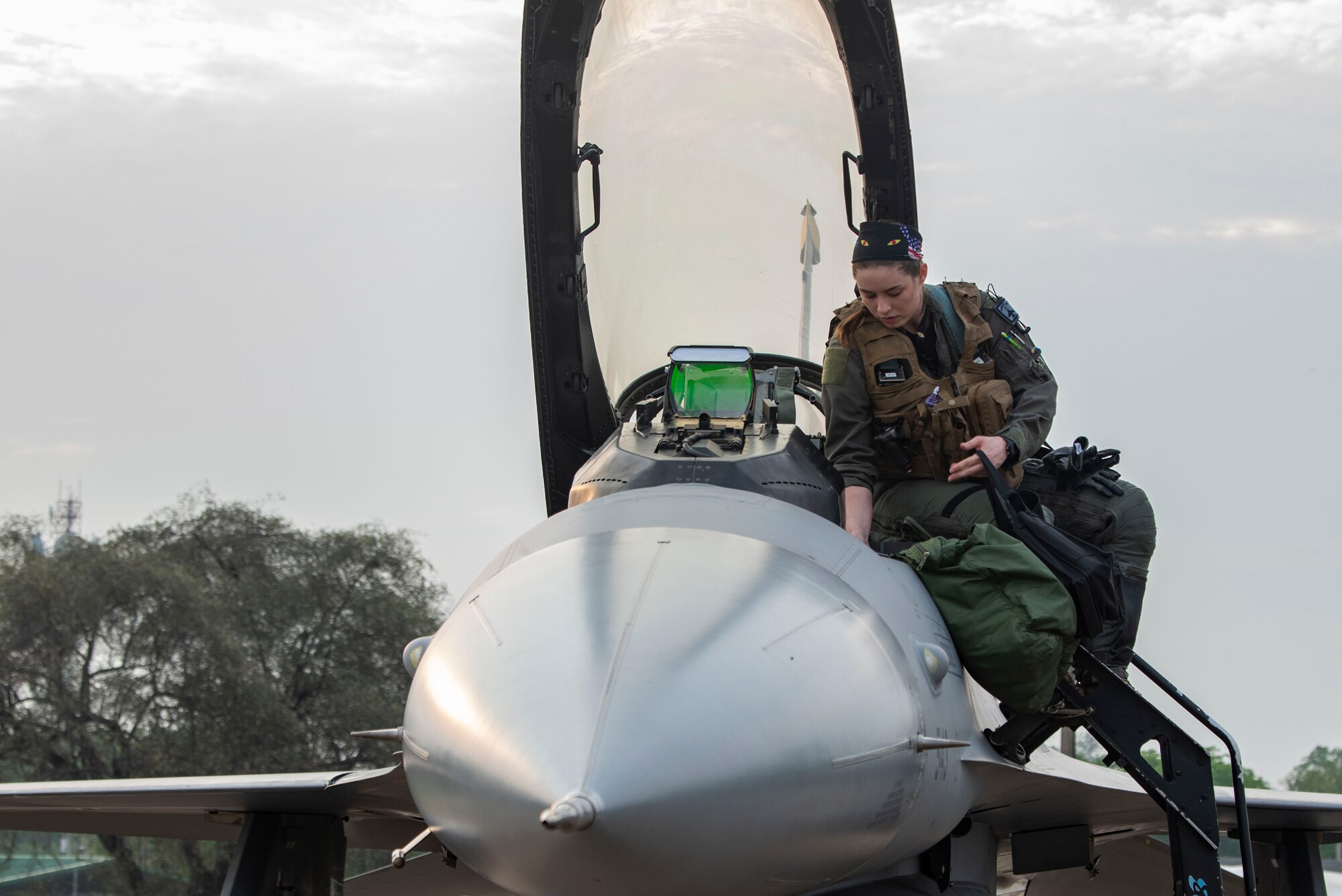 First Lt. Samantha “Force” Colombo, 35th Fighter Squadron pilot, enters an F-16 Fighting Falcon for flight during Cope Tiger 2022 at Korat Royal Thai Air Base, Thailand, March 18,2022. Female fighter pilots officially started flying for the U.S. Air Force in the 1990s. (U.S. Air Force photo by Staff Sgt. Jesenia Landaverde)