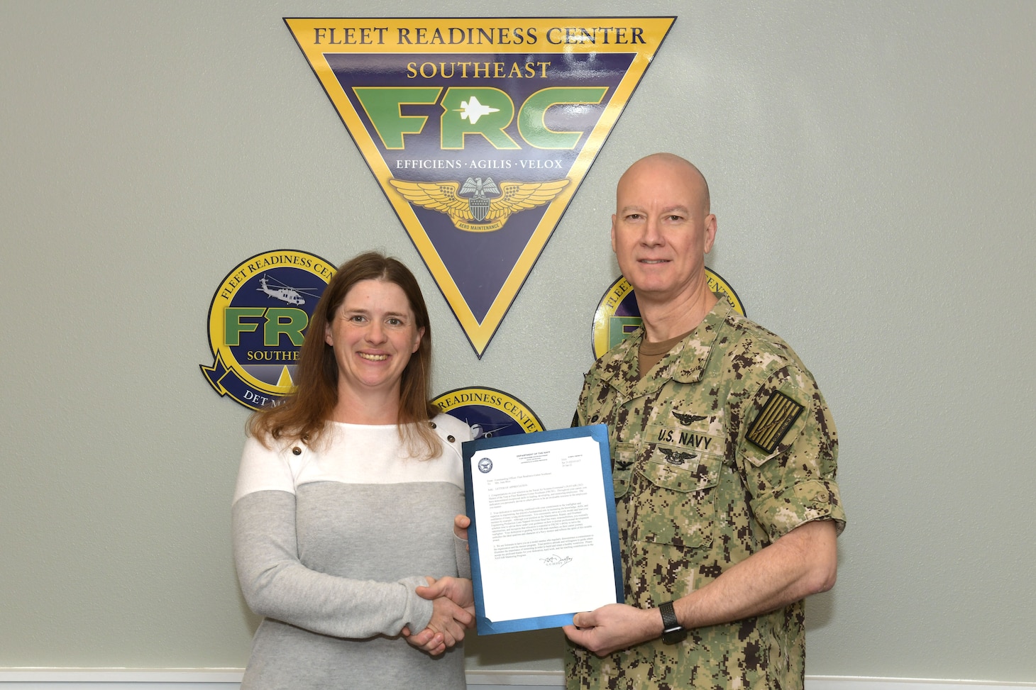 Fleet Readiness Center Southeast (FRCSE) Commanding Officer Capt. Grady Duffey presents Maintenance, Repair and Overhaul Engineering Production Lines Support Division Head, June Bliss, with the Naval Air Systems Command's (NAVAIR) 2021 Mentor of the Year Award. NAVAIR recognizes mentors for their ability to align their development and mentoring skills with the mission of Naval aviation.