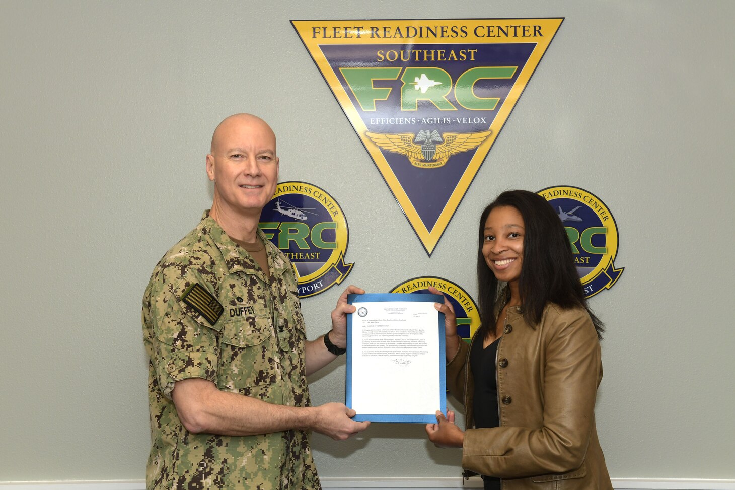 Fleet Readiness Center Southeast (FRCSE) Commanding Officer Capt. Grady Duffey presents Industrial and Chemical Operations Team Lead, Kami Carter, with FRCSE’s 2021 Dora Quinlan Mentor Award. The award is named after former FRCSE Business Operations Director, Dora Quinlan, who earned the first mentor of the year Award from Commander, Fleet Readiness Centers. Quinlan lost her battle with cancer in 2016.