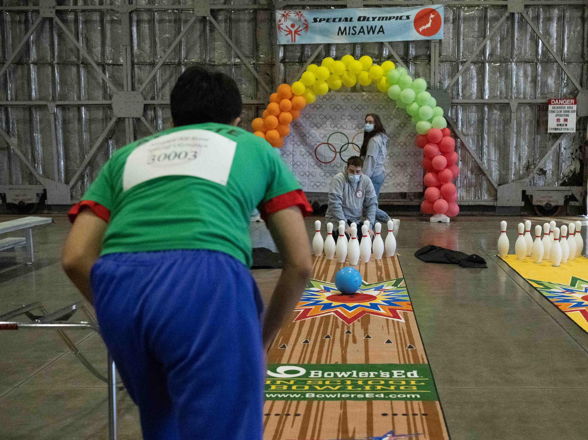 An athlete of the 2022 Misawa Special Olympics rolls a bowling ball during one of the games.