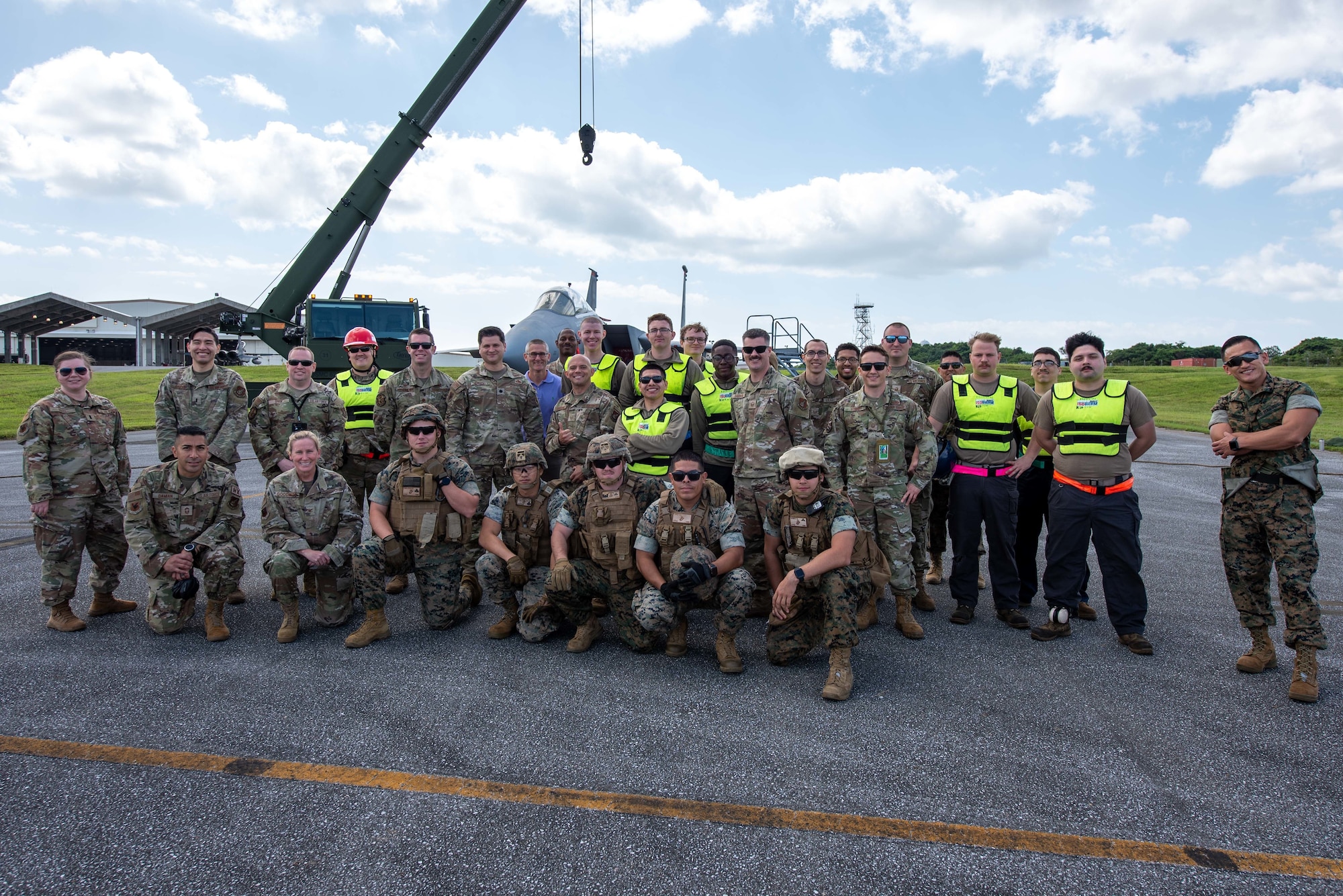 Airmen and Marines pose for a photo.