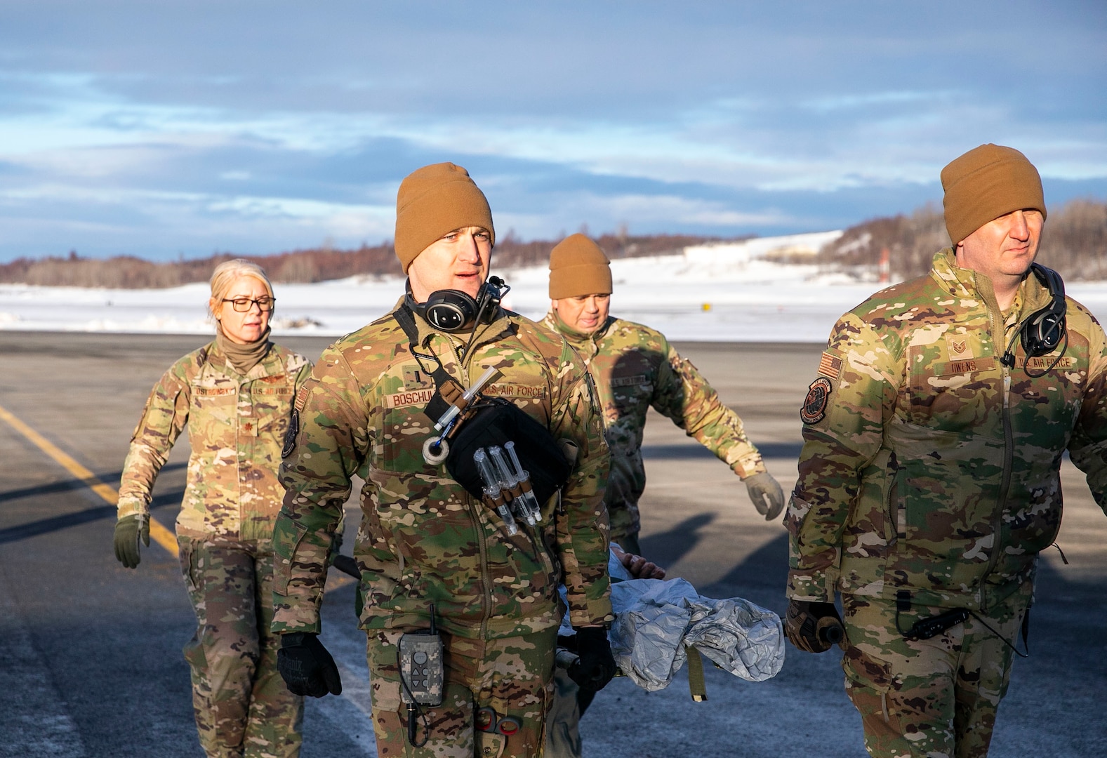 Critical care air transport team personnel load a simulated medical patient during Exercise Arctic Eagle-Patriot 22 at Joint Base Elmendorf-Richardson, Alaska, March 2, 2022. Joint Exercise Arctic Eagle-Patriot 2022 increases the National Guard’s capacity to operate in austere, extreme cold-weather environments across Alaska and the Arctic Region.