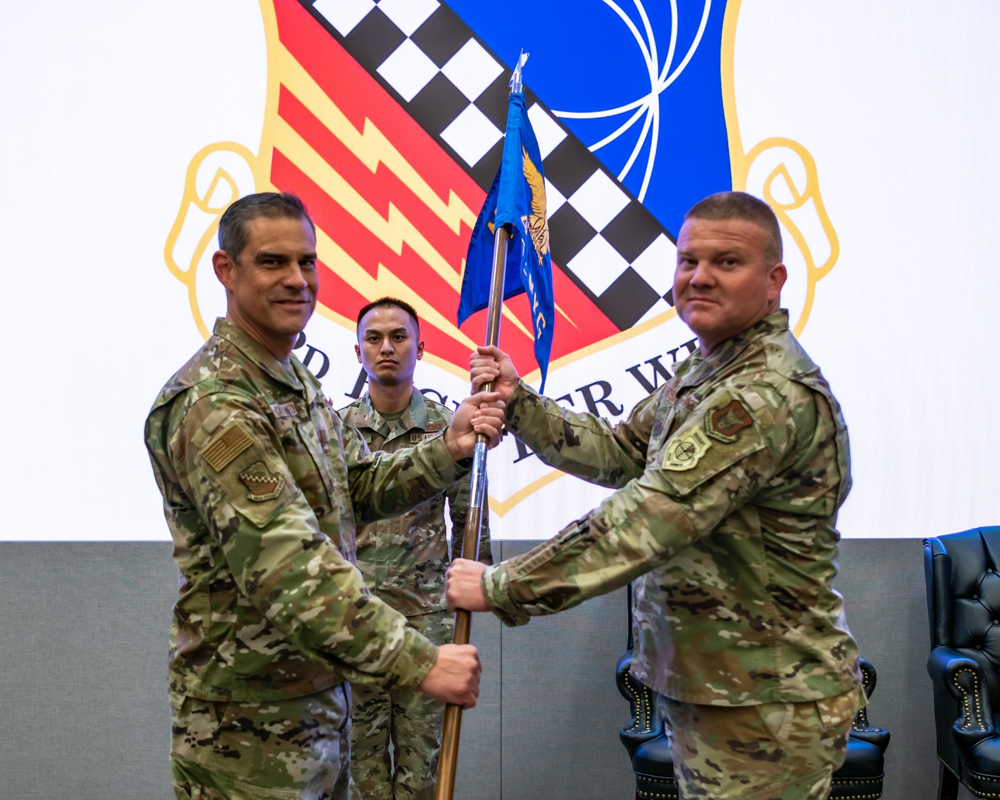Col. Kyle Hosman, right, receives the 482nd Maintenance Group guidon from 482nd Fighter Wing commander Col. David Castaneda during an assumption of command ceremony at Homestead Air Reserve Base, Fla., on March 30, 2022. As commander, Hosman ensures the readiness of over 650 Air Force Reservists, active duty, and civilian members. The maintenance group’s mission is to ensure the air worthiness and combat mission readiness of over 25 F-16C aircraft, supporting the wing’s air combat and tactical training mission. (U.S. Air Force photo by Master Sgt. Allissa Landgraff)