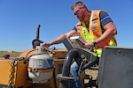 a man checks a generator fuel tank