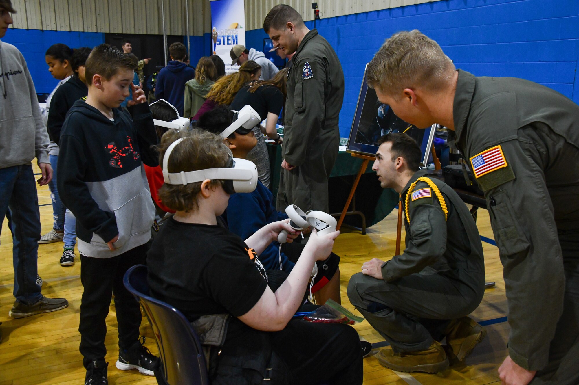 Students from Altus Junior High School use a virtual reality (VR) system operated by students and instructors of the 97th Training Squadron at Altus High School, Altus, Oklahoma, March 30, 2022. The students received the opportunity to simulate in-flight refueling of a C-17 Globemaster III at the Science, Technology, Engineering and Mathematics fair. (U.S. Air Force photo by Airman 1st Class Miyah Gray)
