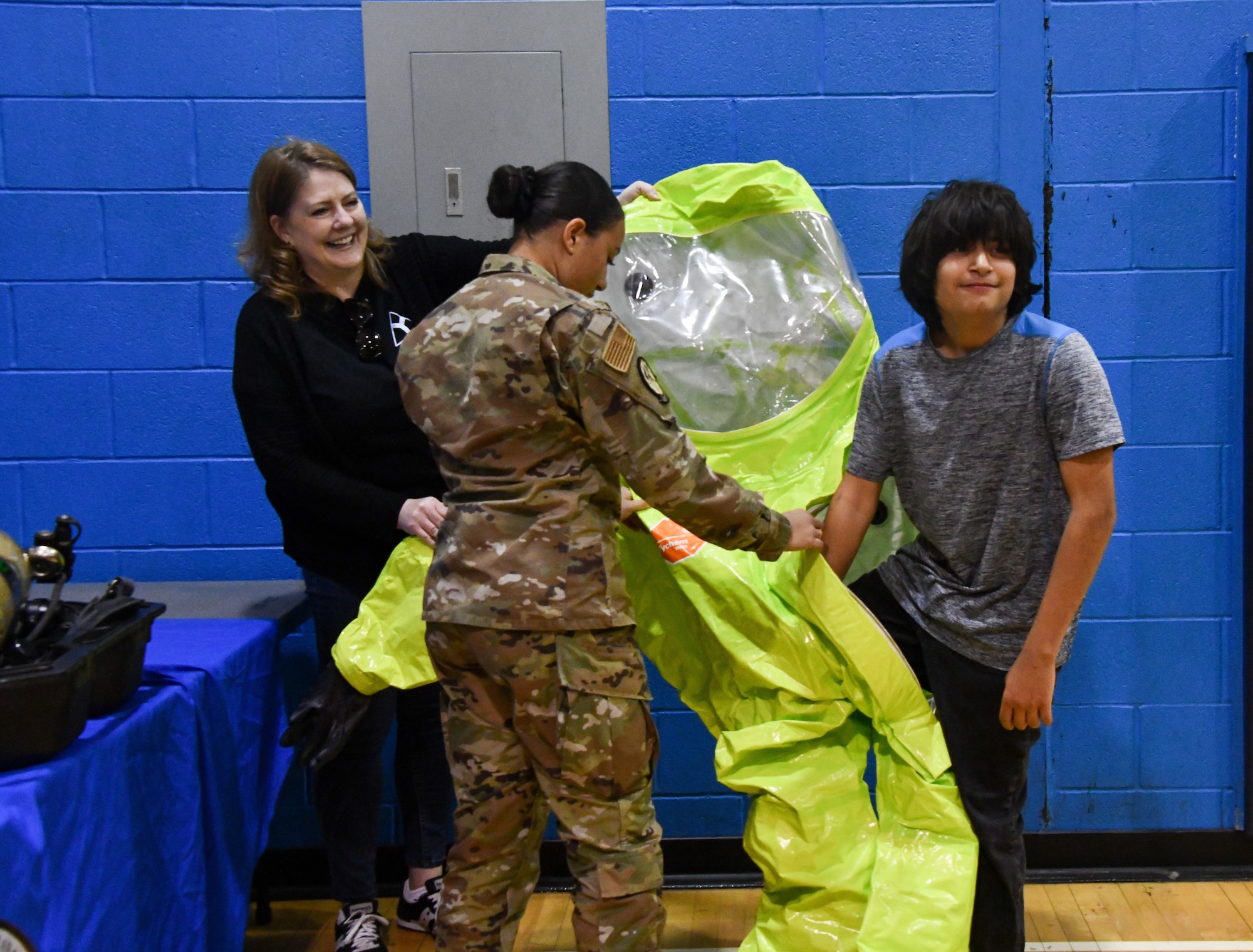 A student from Altus Junior High School tries on a Level A hazardous material (HAZMAT) suit at Altus High School, Altus, Oklahoma, March 30, 2022. Level A HAZMAT suits are utilized by members of the 97th Civil Engineering Squadron’s Readiness and Emergency Management Flight to protect the wearer from hazardous chemicals, biological agents and radioactive materials. (U.S. Air Force photo by Airman 1st Class Miyah Gray)
