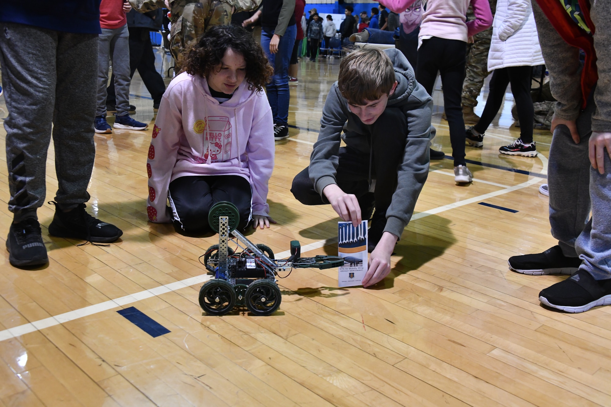 Students from Altus Junior High School play with a robot provided by Altus Air Force Base’s (AAFB) Science, Technology, Engineering and Mathematics (STEM) Council at Altus High School, Altus, Oklahoma, March 30, 2022. AAFB Airmen hosted a STEM fair for  approximately 1,100 local junior and high school students. (U.S. Air Force photo by Airman 1st Class Miyah Gray)