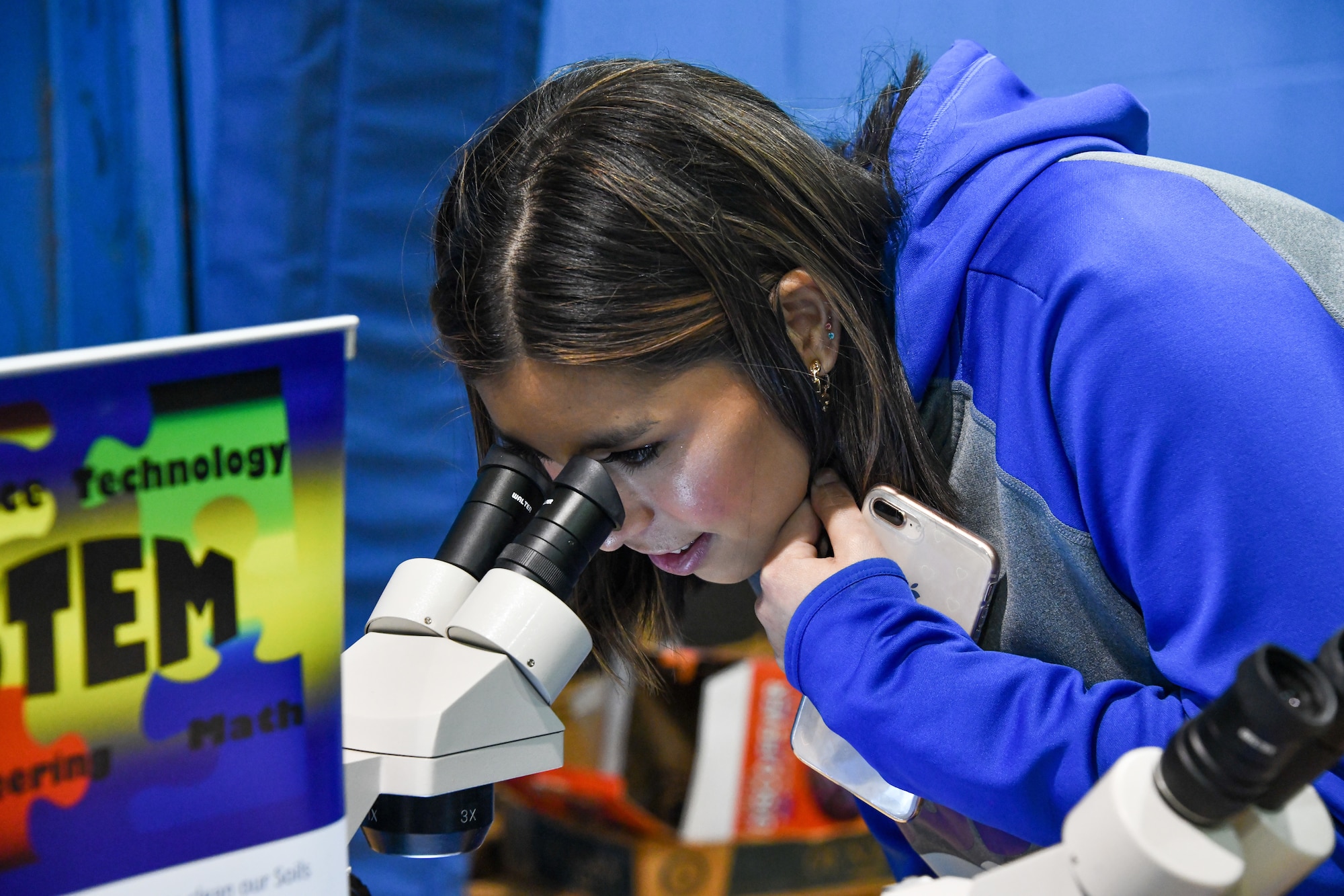 An Altus High School student observes benthic macroinvertebrates under a microscope at Altus High School, Altus, Oklahoma, March 30, 2022. Benthic macroinvertebrates have a range of pollution tolerances, which is helpful in identifying pollutants organically versus taking lab samples. (U.S. Air Force photo by Airman 1st Class Miyah Gray)