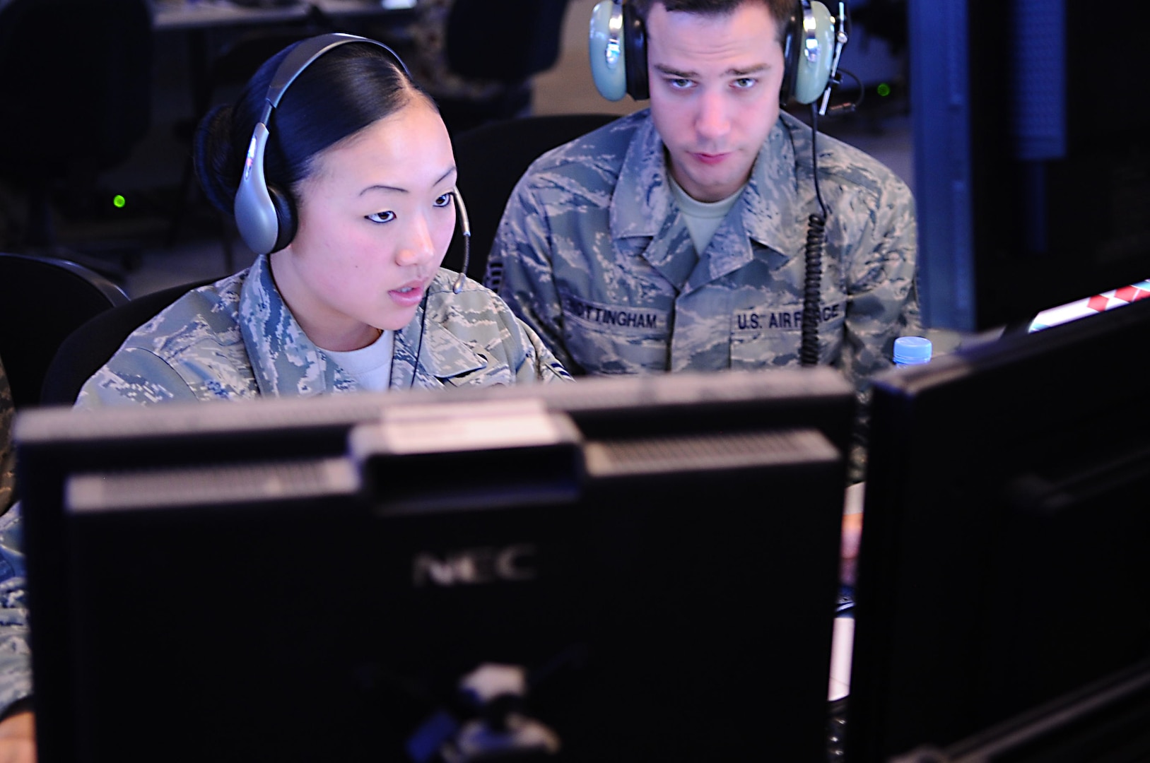 Senior Airman Jennifer Anderson (left) and Staff Sgt. Zachary Nottingham, 71st Expeditionary Air Control Squadron weapons directors, communicate with downrange aircraft from a non-disclosed Southwest Asia location 13 January 2010. The weapons directors help provide troops on the ground with appropriate air support. (Photo by SrA Kasey Zickmund, USAF)