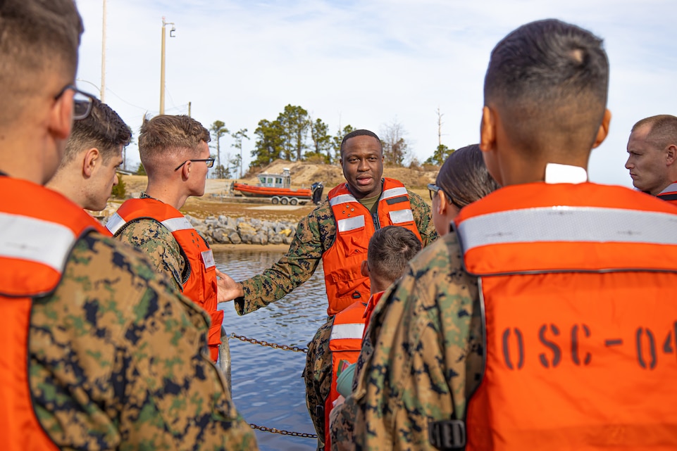 U.S. Marine Corps Capt. Chosnel Raymond, logistics officer with Marine Wing Support Squadron (MWSS) 271, speaks to his Marines while conducting a joint training exercise with Sailors assigned to the Navy Boat Docks on Marine Corps Air Station Cherry Point, North Carolina, Feb. 17, 2022. The Marines of MWSS-271 conducted this exercise in order to test their redesigned internal structure according to the Commandant of the Marine Corps' Force Design 2030. (U.S. Marine Corps photo by Lance. Cpl Noah Braswell)