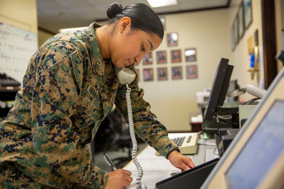 U.S. Marine Corps Lance Cpl. Vanessa Hernandez, an aviation operations supervisor with Headquarters and Headquarters Squadron, Marine Corps Air Station New River, answers the phone on MCAS New River in Jacksonville, North Carolina, Nov. 23, 2021. Hernandez, the winner of the November MCAS New River Go-Getter award, enlisted in the Marine Corps in July of 2019 from Somerset, New Jersey.