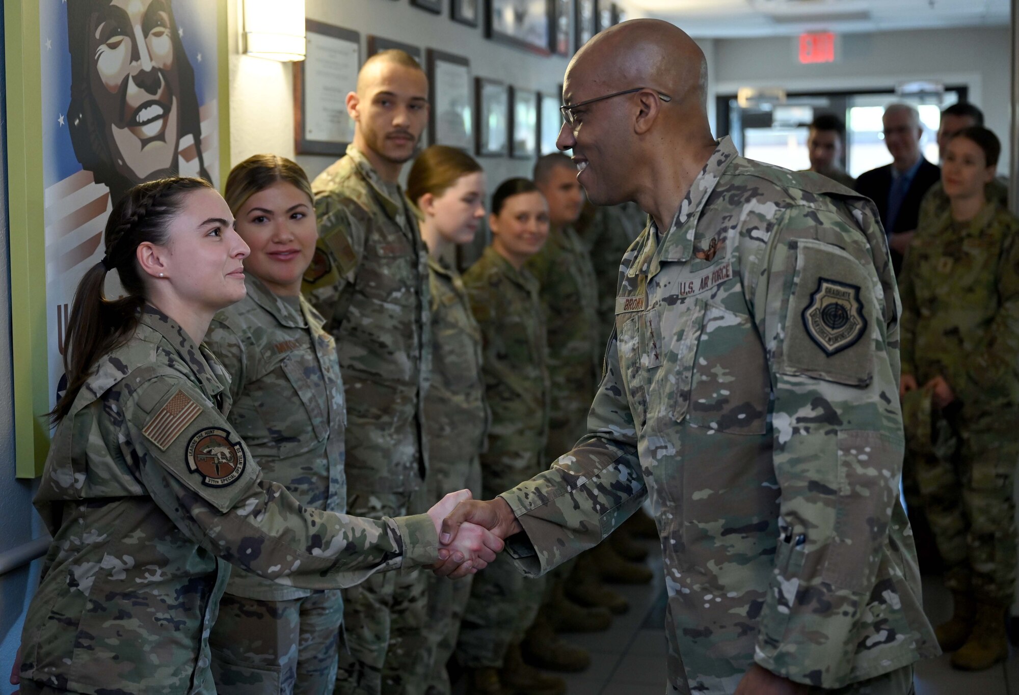 Air Force Chief of Staff Gen. CQ Brown, Jr., greets U.S. Air Force Senior Airman Myah Periman, tactical system operator with the 311th Special Operations Intelligence Squadron, during a lunch with junior enlisted Airmen at Hurlburt Field, Florida, April 4, 2022. During his visit, Brown also received command updates from Headquarters AFSOC staff and briefings on Mission Sustainment Teams, Aviation Special Operations Task Units and Special Operations Task Groups. (U.S. Air Force photo by Staff Sgt. Brandon Esau)