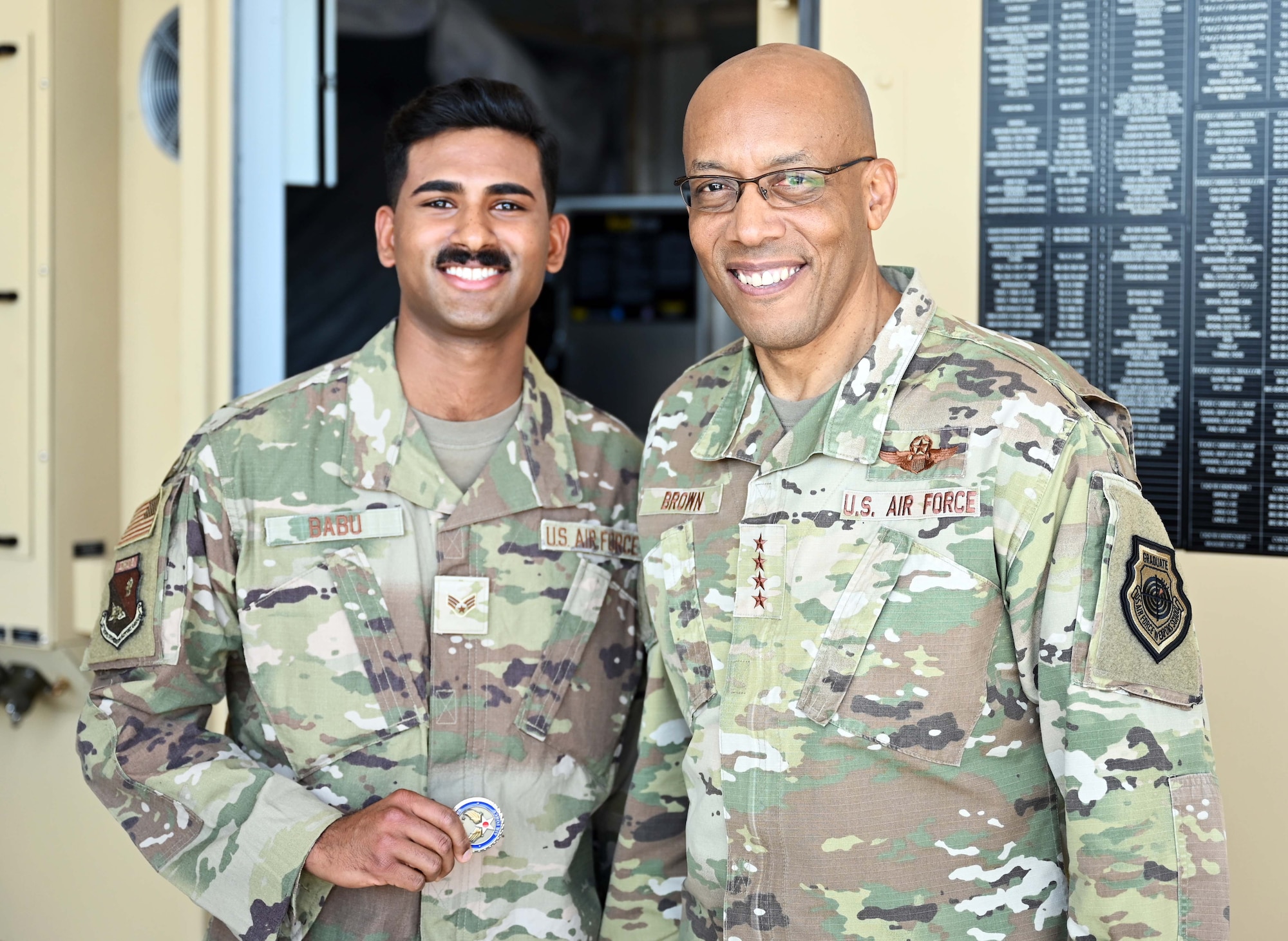 Air Force Chief of Staff Gen. CQ Brown, Jr., presents a coin to U.S. Air Force Senior Airman Abel Babu, cargo movement specialist with the 27th Special Operations Mission Support Group, Detachment 1, Cannon Air Force Base, New Mexico, during his visit to Hurlburt Field, Florida, April, 4, 2022. During his visit, Brown also received command updates from Headquarters Air Force Special Operations Command staff and briefings on Mission Sustainment Teams, Aviation Special Operations Task Units and Special Operations Task Groups. (U.S. Air Force photo by Staff Sgt. Brandon Esau)
