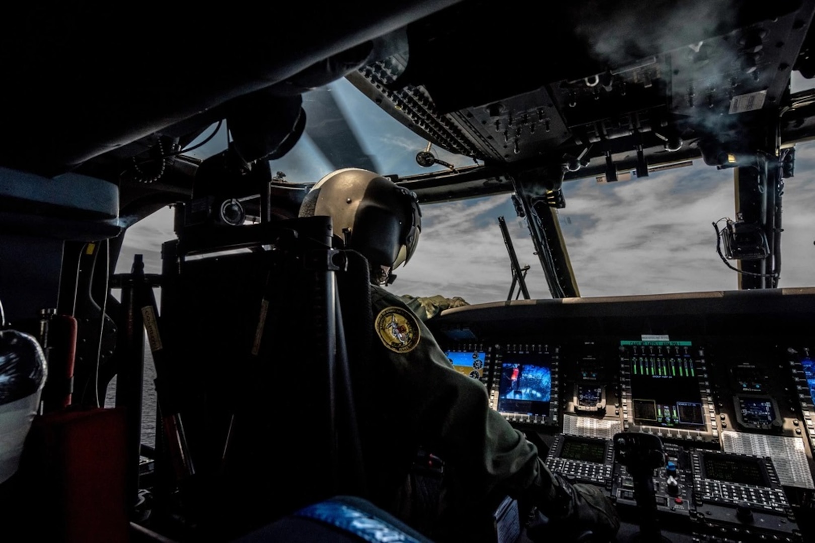 A Coast Guard MH-60 Jayhawk helicopter pilot from Air Station Elizabeth City, N.C., flies a Jayhawk on a training mission June 14, 2016. Jayhawk aircrews typically consist of two pilots, a flight mechanic and rescue swimmer. (U.S. Coast Guard photo by Auxiliarist David Lau)