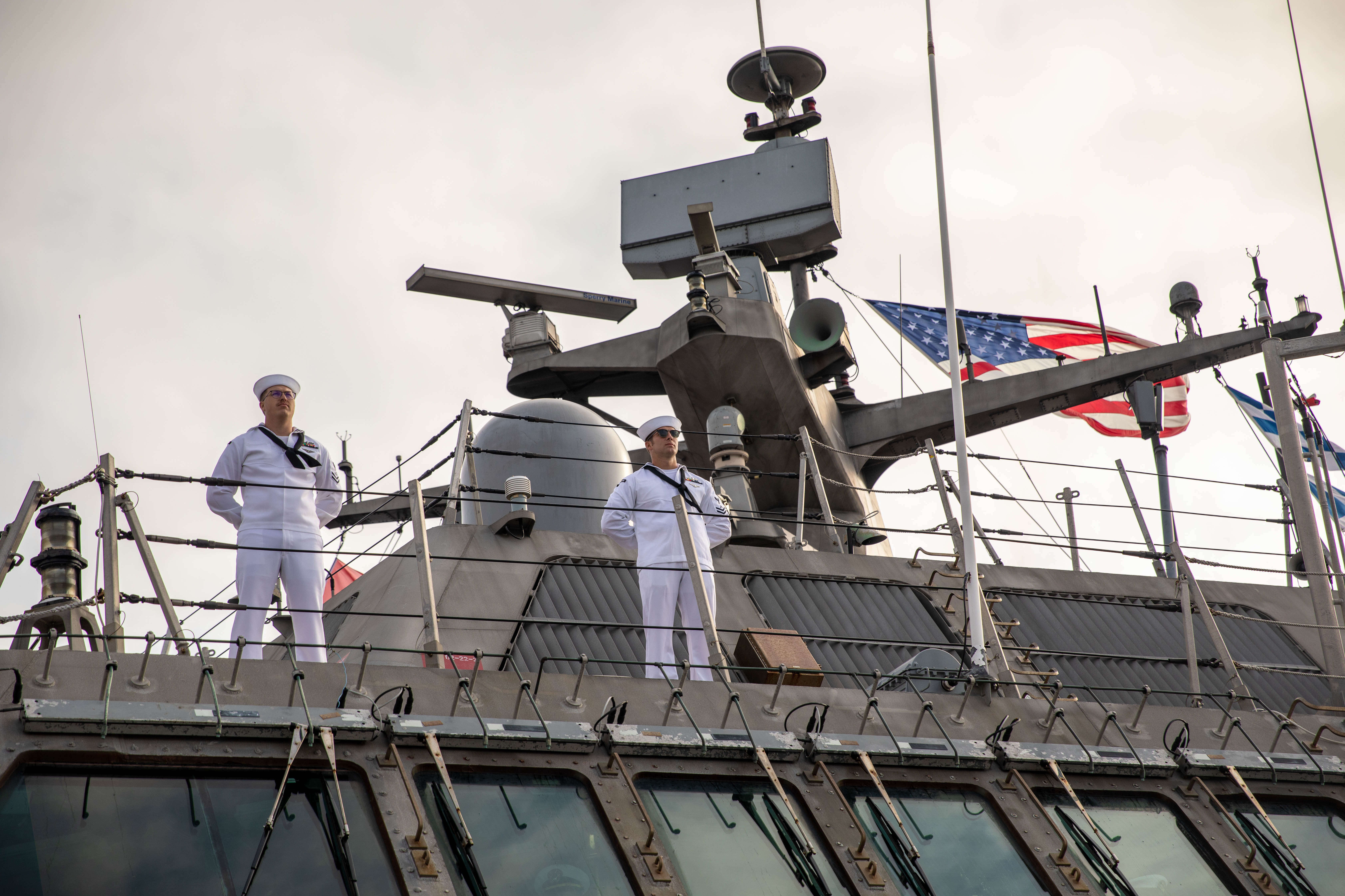 Information Systems Technician 2nd Class Slade Dubberly and Gunner’s Mate 2nd Class Edward Kawczak man the rails aboard the Freedom-variant littoral combat ship USS Milwaukee (LCS 5) as the ship returns from deployment to Naval Station Mayport.