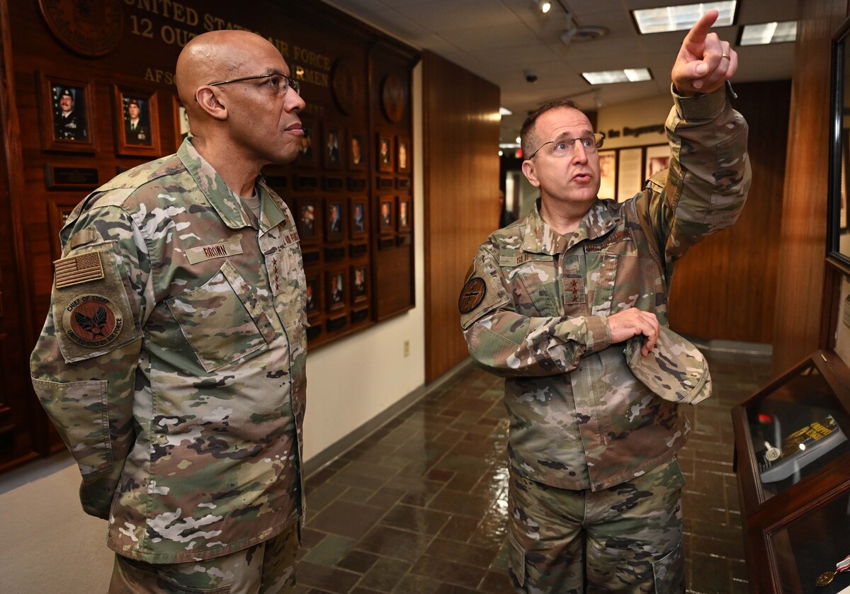 Air Force Chief of Staff Gen. CQ Brown, Jr., receives a headquarters tour from Lt. Gen. Jim Slife, commander of Air Force Special Operations Command, during a visit to Hurlburt Field, Fla., April 4, 2022. During his visit, Brown met with junior enlisted Airmen and received command updates from Headquarters AFSOC staff and briefings on Mission Sustainment Teams, Aviation Special Operations Task Units and Special Operations Task Groups. (U.S. Air Force photo by Staff Sgt. Brandon Esau)