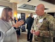 Joint Task Force Civil Support Chief of Staff Col. Christopher Caldwell, right, talks with an industry partner about defense support to civil authorities during Defense Strategies Institute’s Joint Civil and DoD CBRN symposium at the National Harbor in Maryland, March 23, 2022.