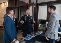 Joint Task Force Civil Support Chief of Staff Col. Christopher Caldwell, center, speaks with industry partners about equipment modernization during Defense Strategies Institute’s Joint Civil and DoD CBRN symposium at the National Harbor in Maryland, March 24, 2022.