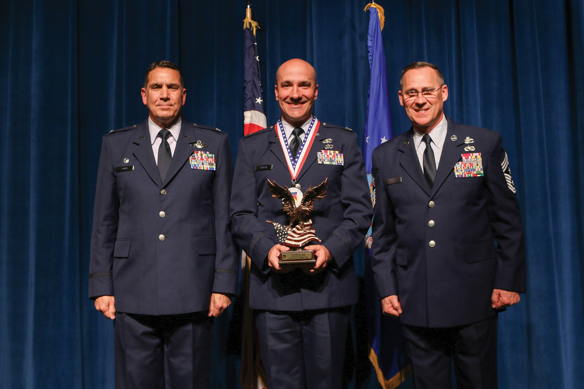 Maj. Phillip Sobers, 445th Logistics Readiness Squadron, accepts the 2021 Field Grade Officer of the Year award during the 445th Airlift Wing's Annual Awards Recognition Ceremony April 2, 2022. The event recognized 34 nominees. Col. Raymond Smith, 445th AW commander and Chief Master Sgt. Christopher Williams, presented medallions to nominees and a trophy to the winners. Mrs. Stephanie Smith, 445th Airlift Wing Key Spouse Mentor and wife of Col. Smith, presented the spouse and youth nominees their medallions and trophies to the winners.