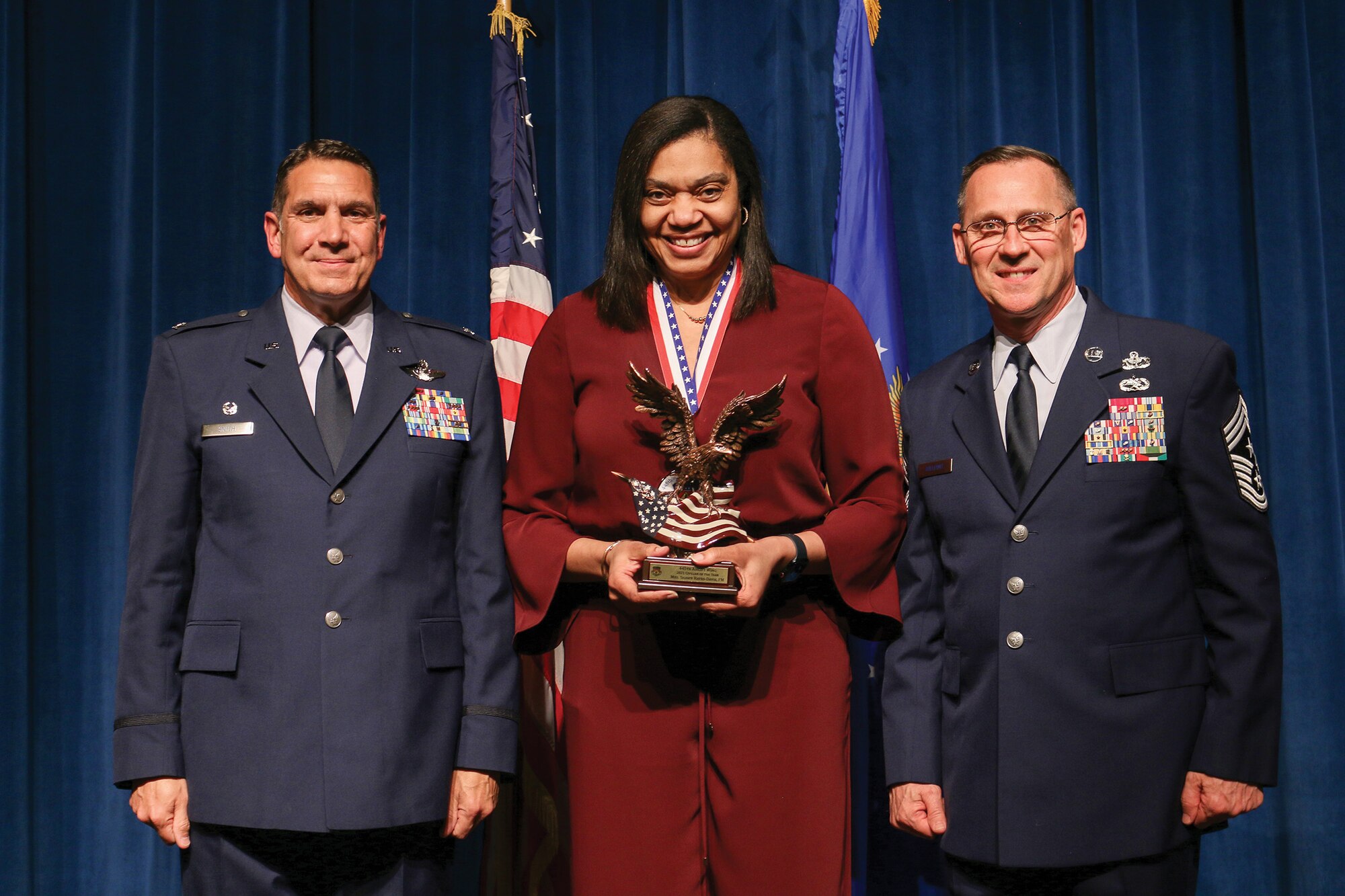 Mrs. Shawn Hayes-Davis, 445th Airlift Wing Financial Management, accepts the 2021 Civilian of the Year award during the 445th Airlift Wing's Annual Awards Recognition Ceremony April 2, 2022. The event recognized 34 nominees. Col. Raymond Smith, 445th AW commander and Chief Master Sgt. Christopher Williams, presented medallions to nominees and a trophy to the winners. Mrs. Stephanie Smith, 445th Airlift Wing Key Spouse Mentor and wife of Col. Smith, presented the spouse and youth nominees their medallions and trophies to the winners.