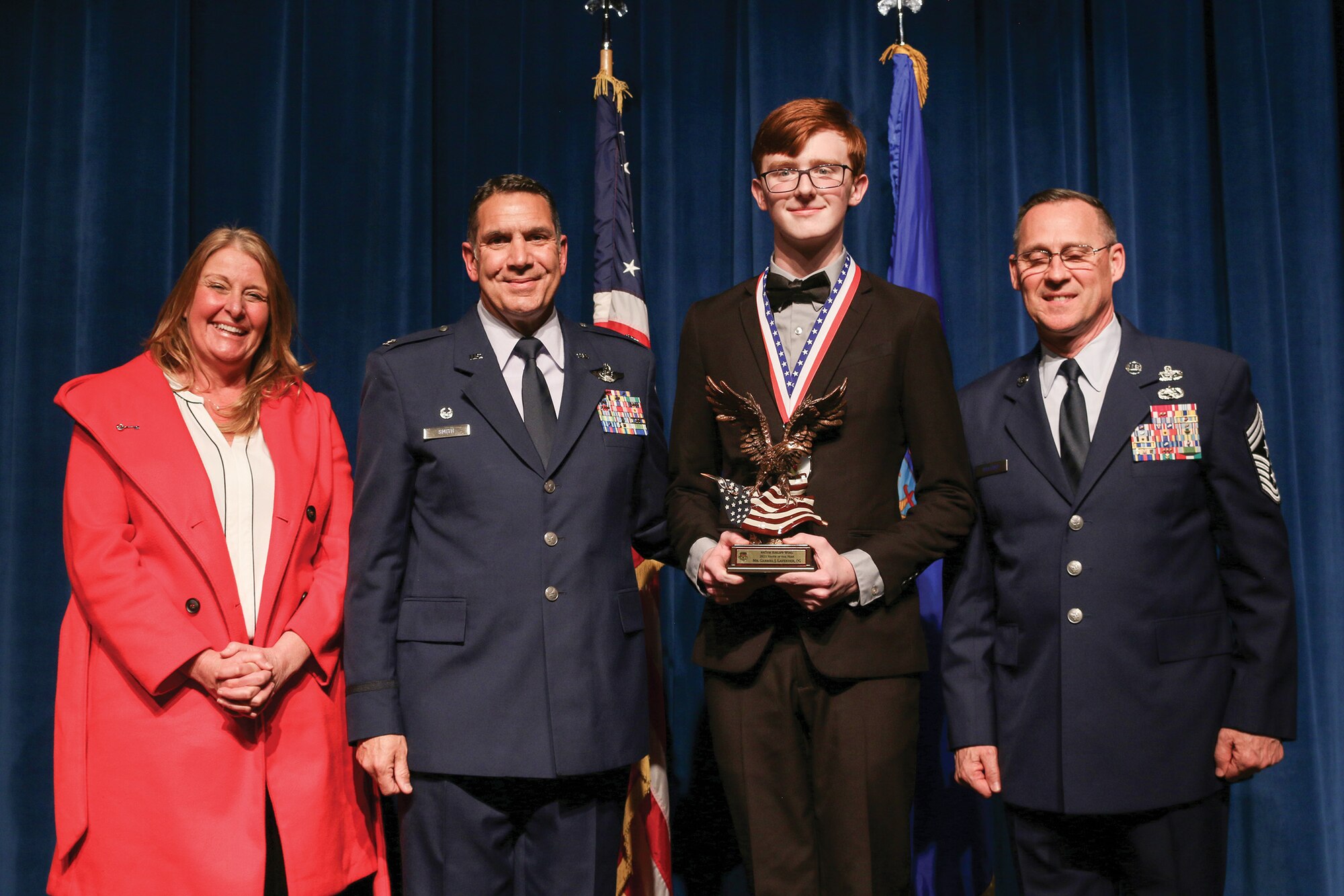 Mr. Gabriel Lavender, son of Mr. Shad Lavender, 445th Operations Group, accepts the 2021 Youth of the Year award during the 445th Airlift Wing's Annual Awards Recognition Ceremony April 2, 2022. The event recognized 34 nominees. Col. Raymond Smith, 445th AW commander and Chief Master Sgt. Christopher Williams, presented medallions to nominees and a trophy to the winners. Mrs. Stephanie Smith, 445th Airlift Wing Key Spouse Mentor and wife of Col. Smith, presented the spouse and youth nominees their medallions and trophies to the winners.