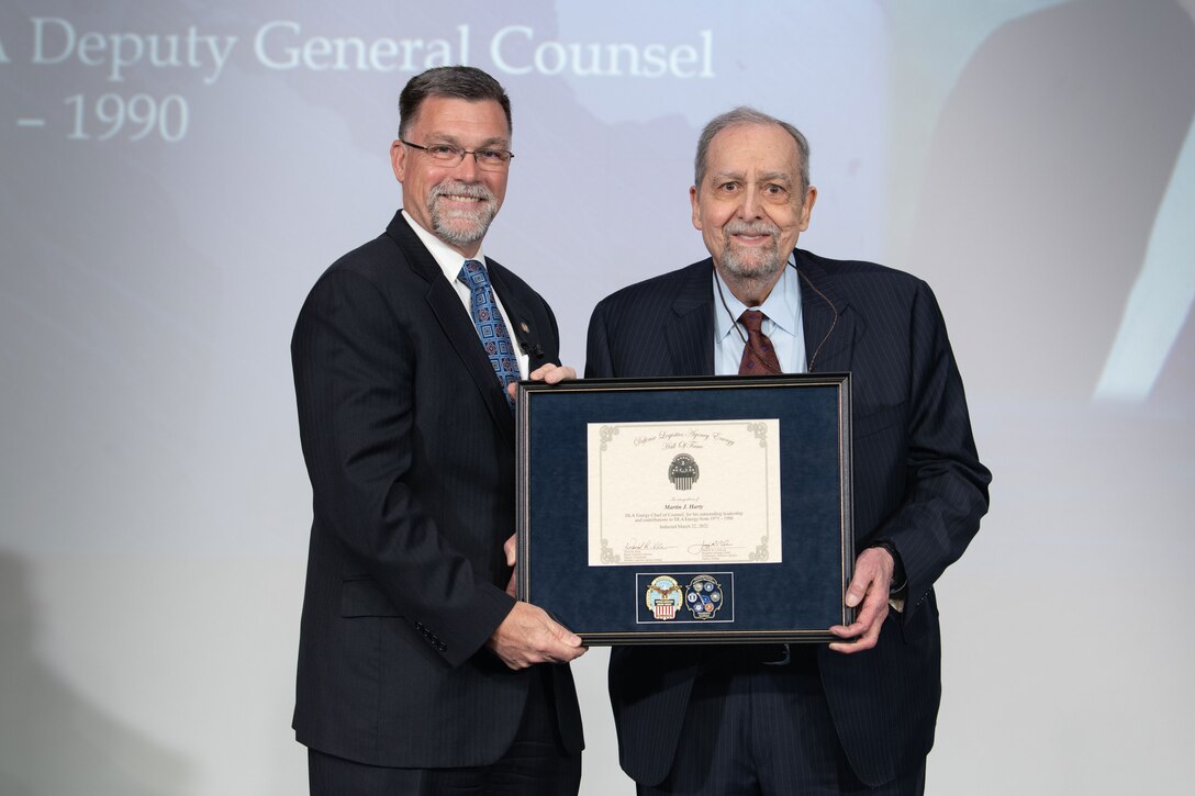 Martin Harty receives a plaque from DLA Energy Deputy Command David Kless
