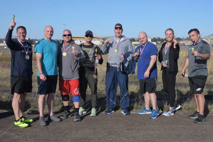 Members of the 111th Attack Wing show off their victory trophies and medals after completing the sexual assault awareness and prevention month 5k on Saturday, April 2, 2022 at Biddle Air National Guard Base, Horsham, PA. The 111th Attack Wing sexual assault response coordinator hosted the run to support sexual assault awareness and prevention month.