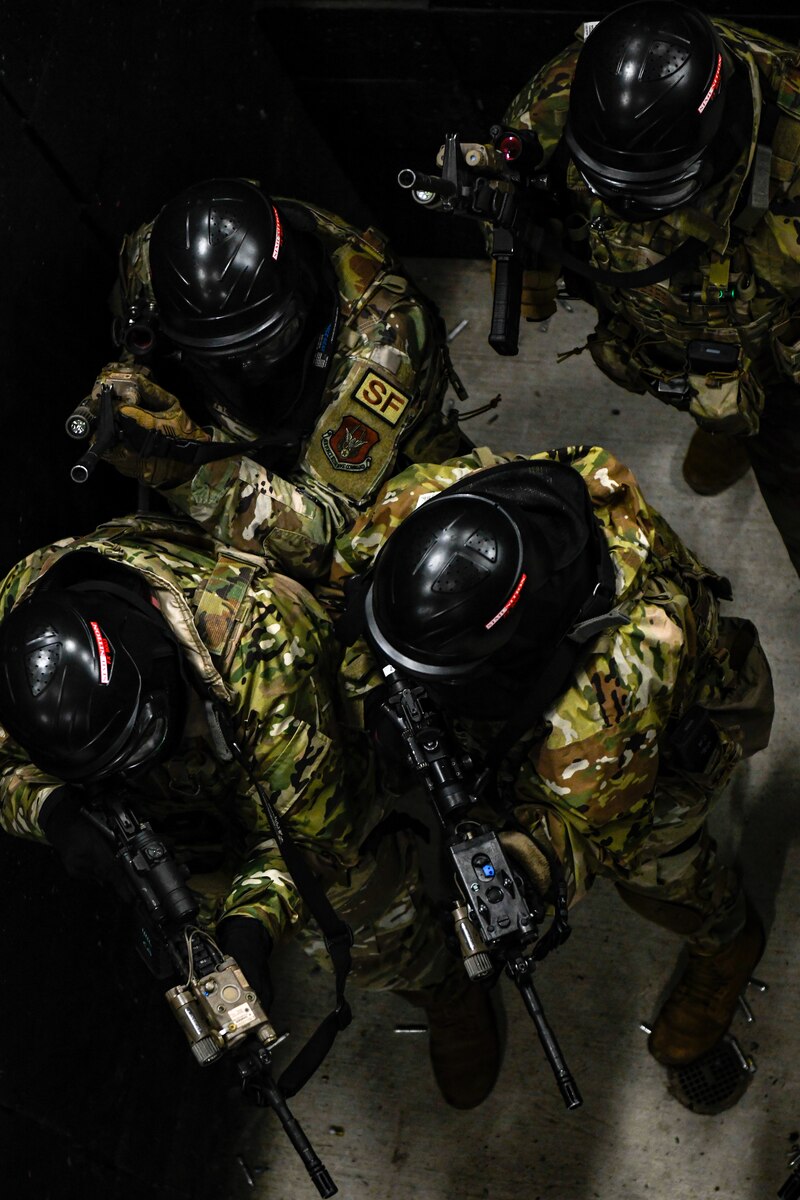 Air Force Reserve Command Defenders assigned to the 446th Security Forces Squadron, Joint Base Lewis-McChord, Washington, work their way through a live-fire training scenario, March 20, 2022, at the shoot-house at Camp James A. Garfield Joint Military Training Center, Ohio.