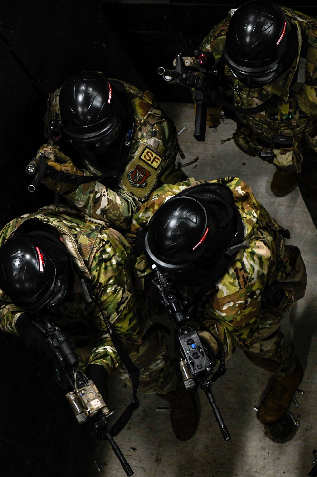 Air Force Reserve Command Defenders assigned to the 446th Security Forces Squadron, Joint Base Lewis-McChord, Washington, work their way through a live-fire training scenario, March 20, 2022, at the shoot-house at Camp James A. Garfield Joint Military Training Center, Ohio.