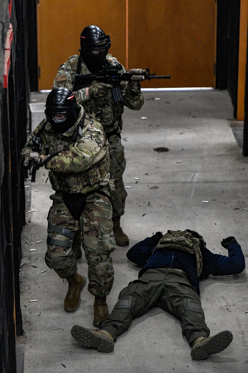 Air Force Reserve Command Defenders assigned to the 446th Security Forces Squadron, Joint Base Lewis-McChord, Washington, work their way through a live-fire training scenario, March 20, 2022, at the shoot-house at Camp James A. Garfield Joint Military Training Center, Ohio.