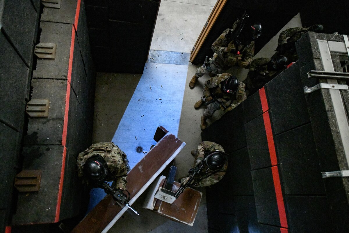 Air Force Reserve Command Defenders assigned to the 446th Security Forces Squadron, Joint Base Lewis-McChord, Washington, work their way through a live-fire training scenario, March 20, 2022, at the shoot-house at Camp James A. Garfield Joint Military Training Center, Ohio.