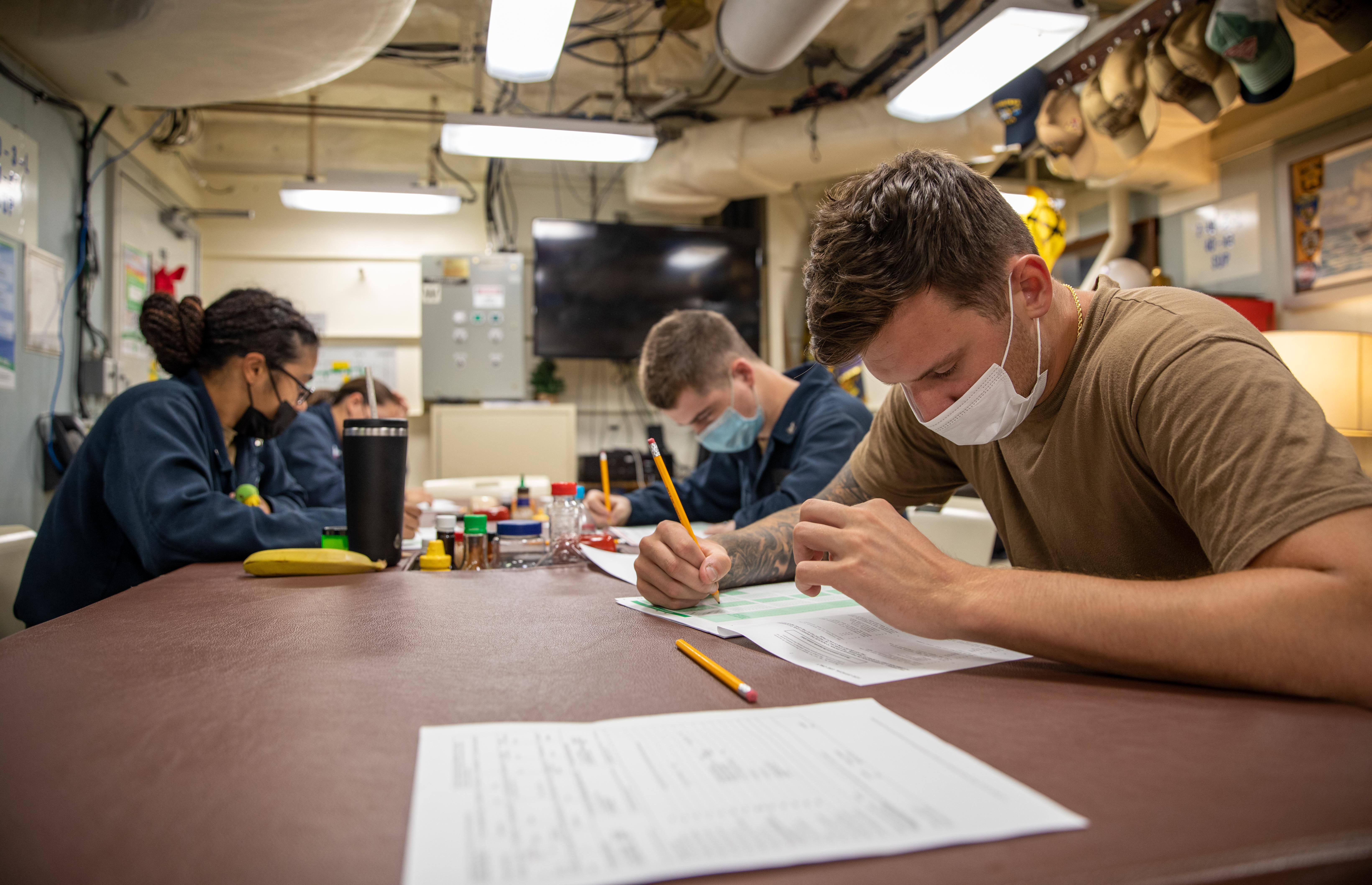 Sailors take the Navy wide Advancement Exam for E-5 candidates aboard the Freedom-variant littoral combat ship USS Milwaukee (LCS 5), March 29, 2022.