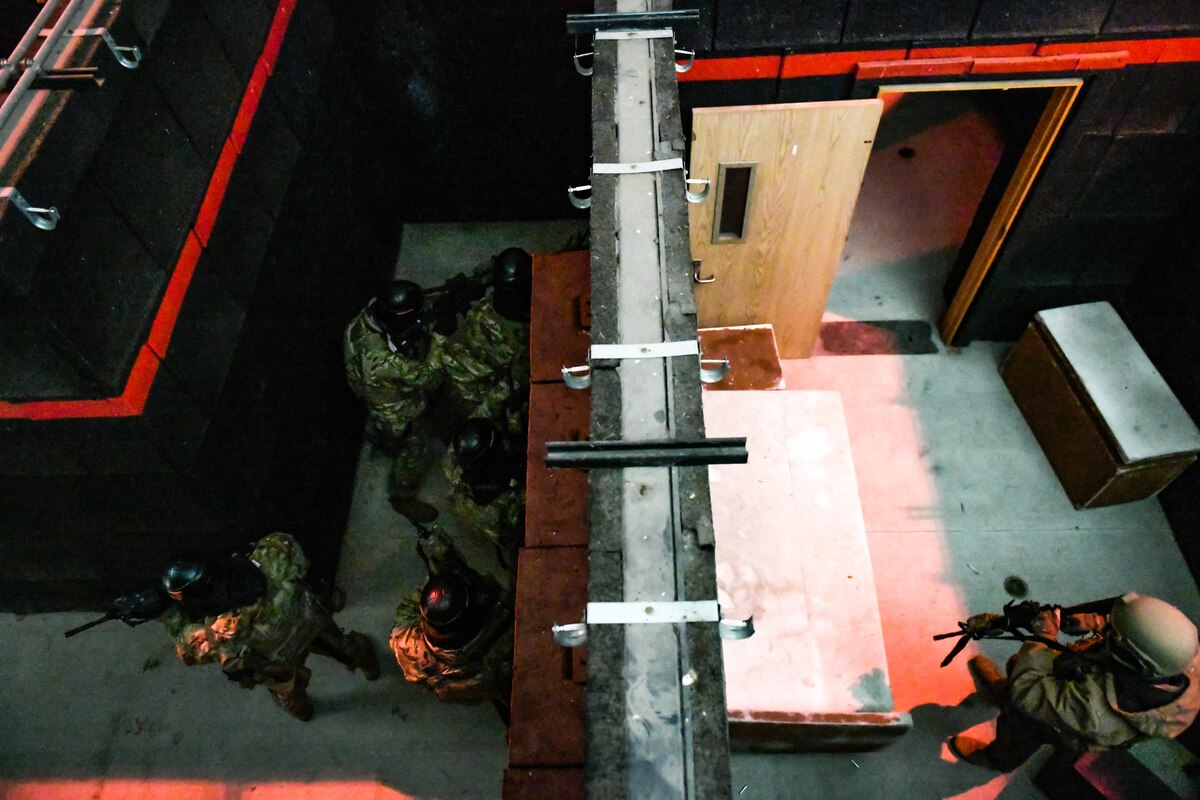 Air Force Reserve Command Defenders assigned to the 446th Security Forces Squadron, Joint Base Lewis-McChord, Washington, work their way through a live-fire training scenario, March 20, 2022, at the shoot-house at Camp James A. Garfield Joint Military Training Center, Ohio.