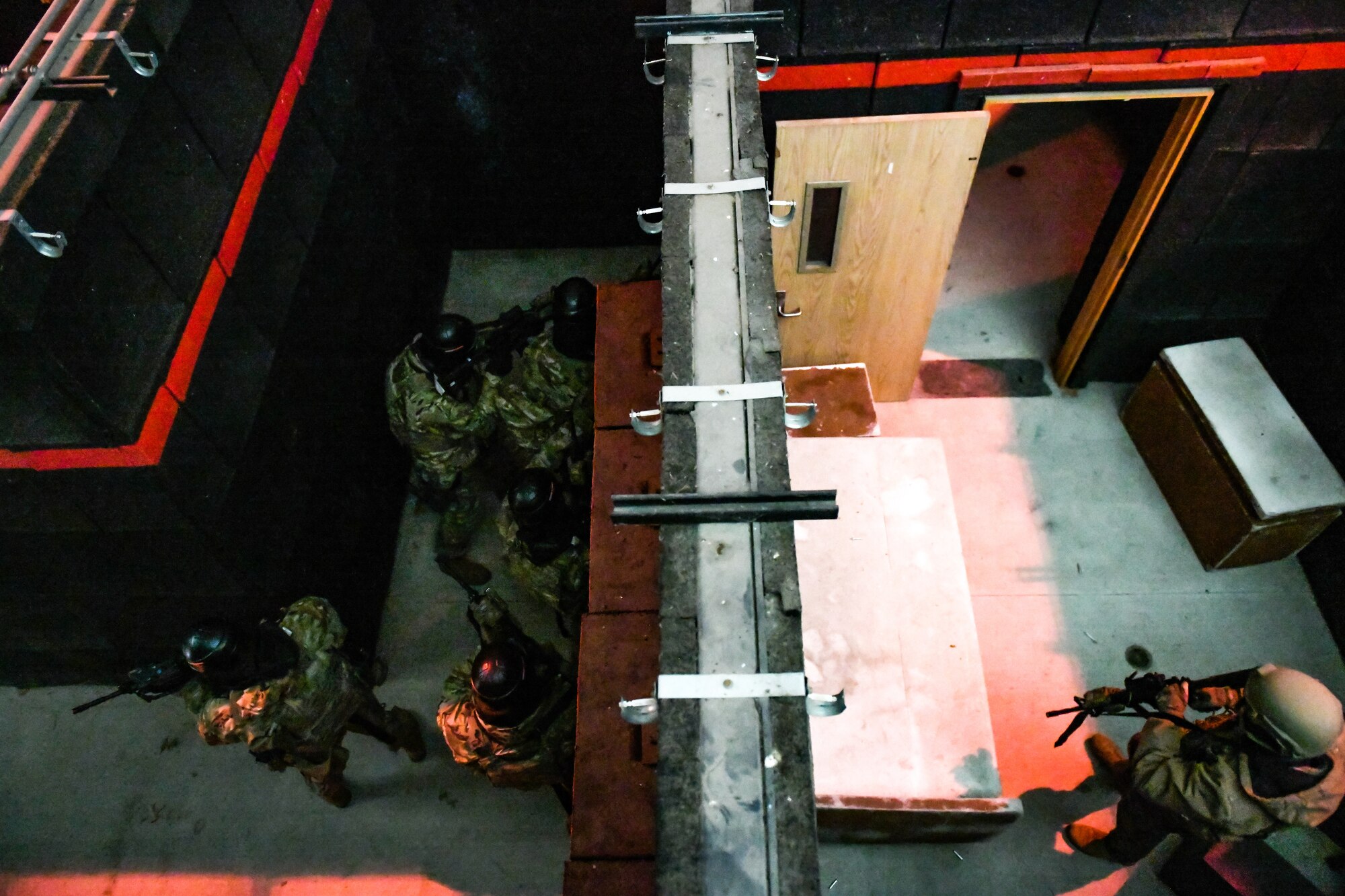 Air Force Reserve Command Defenders assigned to the 446th Security Forces Squadron, Joint Base Lewis-McChord, Washington, work their way through a live-fire training scenario, March 20, 2022, at the shoot-house at Camp James A. Garfield Joint Military Training Center, Ohio.