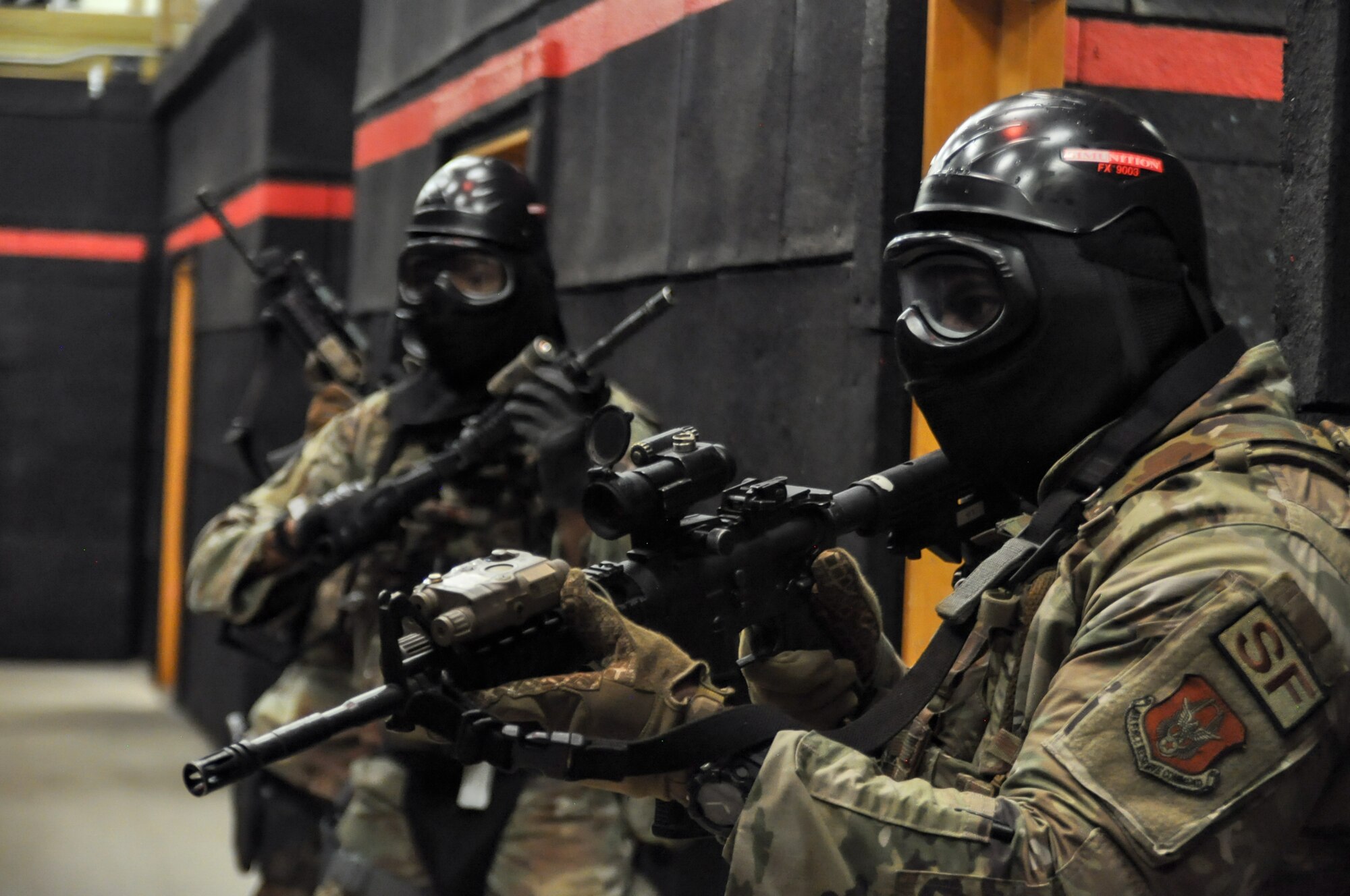 Air Force Reserve Command Defenders assigned to the 446th Security Forces Squadron, Joint Base Lewis-McChord, Washington, work their way through a live-fire training scenario, March 20, 2022, at the shoot-house at Camp James A. Garfield Joint Military Training Center, Ohio.
