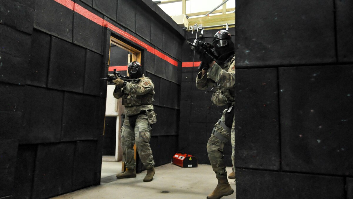 Air Force Reserve Command Defenders assigned to the 446th Security Forces Squadron, Joint Base Lewis-McChord, Washington, work their way through a live-fire training scenario, March 20, 2022, at the shoot-house at Camp James A. Garfield Joint Military Training Center, Ohio.