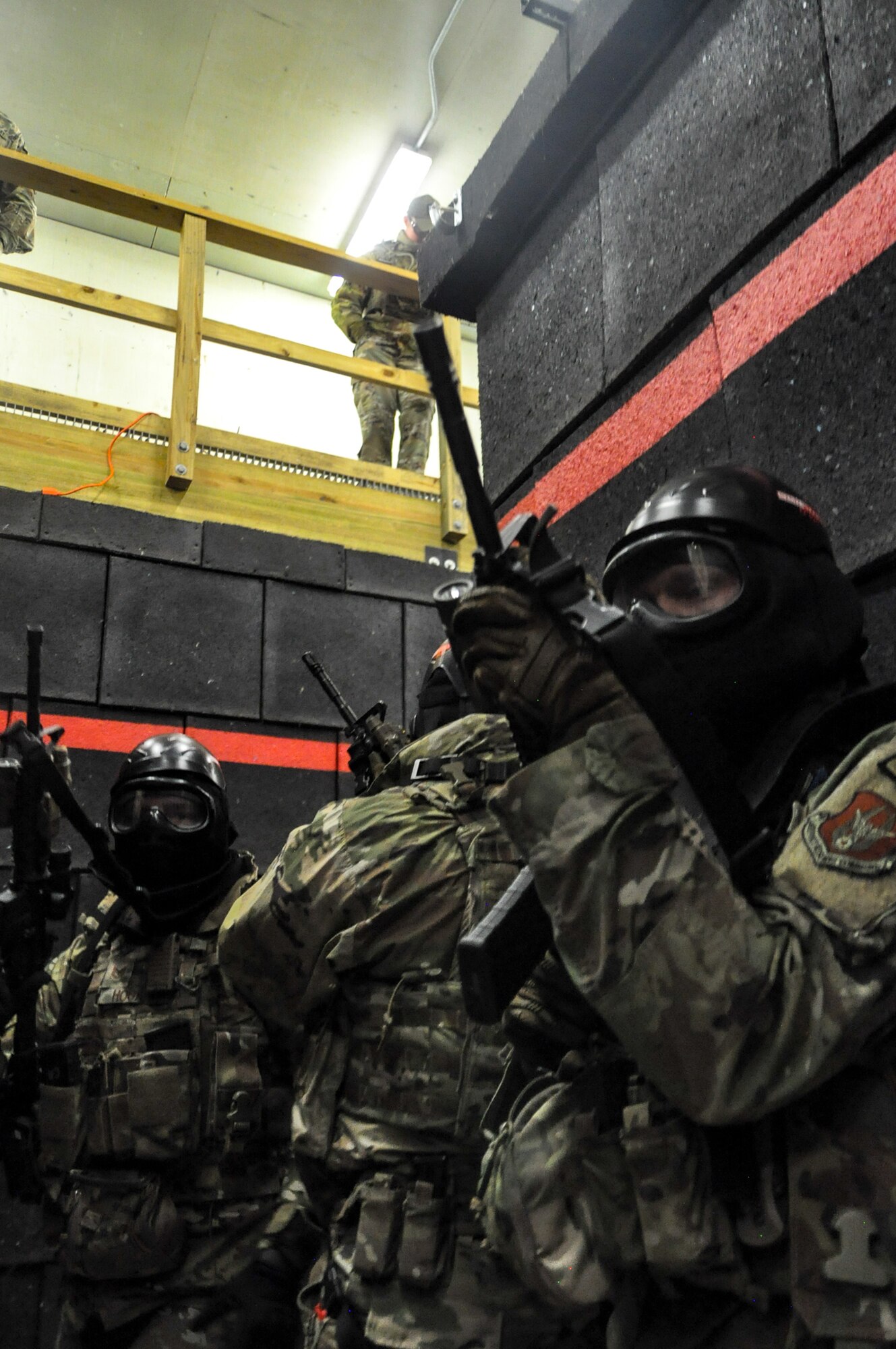 Air Force Reserve Command Defenders assigned to the 446th Security Forces Squadron, Joint Base Lewis-McChord, Washington, work their way through a live-fire training scenario, March 20, 2022, at the shoot-house at Camp James A. Garfield Joint Military Training Center, Ohio.