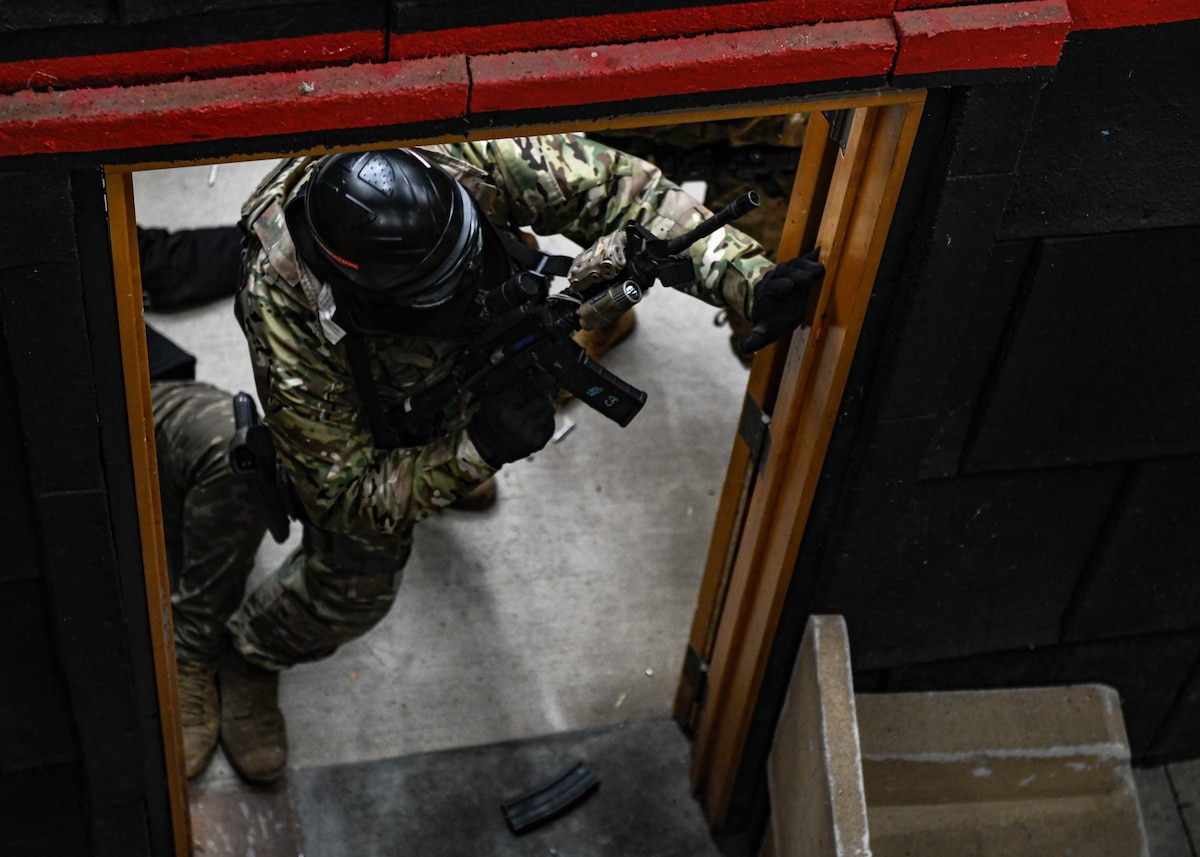 Air Force Reserve Command Defenders assigned to the 446th Security Forces Squadron, Joint Base Lewis-McChord, Washington, work their way through a live-fire training scenario, March 20, 2022, at the shoot-house at Camp James A. Garfield Joint Military Training Center, Ohio.