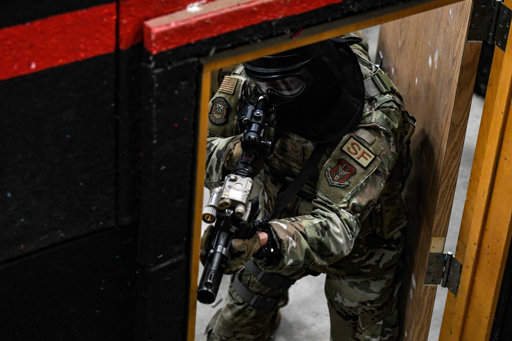 Air Force Reserve Command Defenders assigned to the 446th Security Forces Squadron, Joint Base Lewis-McChord, Washington, work their way through a live-fire training scenario, March 20, 2022, at the shoot-house at Camp James A. Garfield Joint Military Training Center, Ohio.
